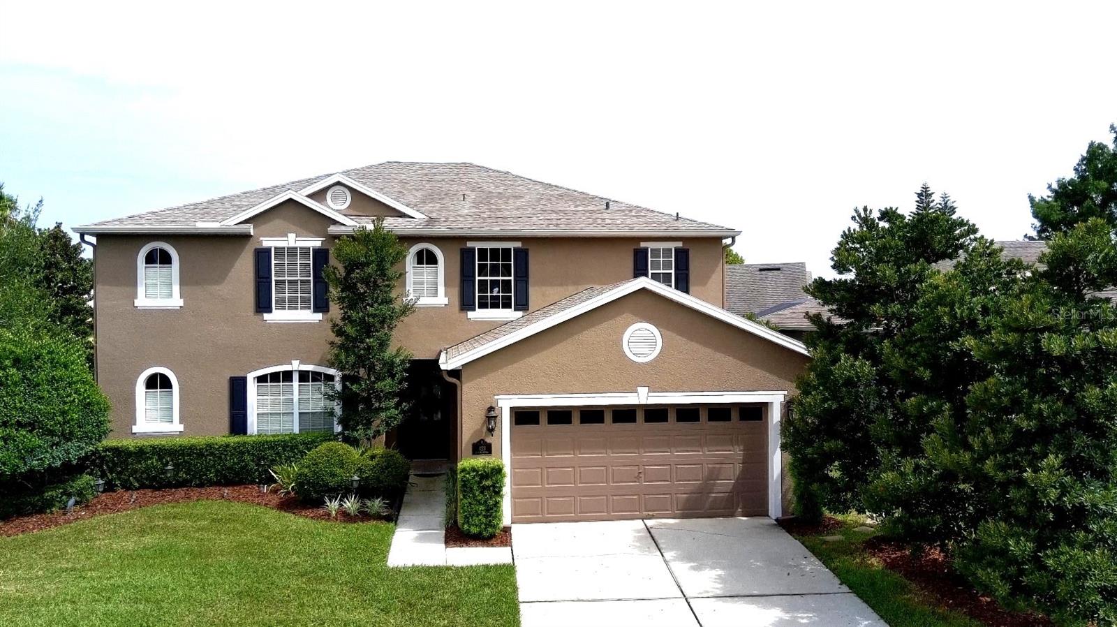 Nestled in the highly sought-after community of Parkstone, this stunning 3,512 sq. ft. home boasts exceptional craftsmanship and thoughtful details throughout. From the moment you step inside, the rich wood floors seamlessly flow through the open-concept floor plan, setting the tone for this inviting and spacious home. With two primary suites and an additional ensuite bedroom, this home offers multiple private retreats, each with walk-in closets and spacious bathrooms, providing ultimate comfort and privacy. A brand-new roof, installed in 2022, offers peace of mind for years to come. Step outside to discover a private backyard oasis—perfect for relaxing, entertaining, or simply unwinding in serene surroundings. The expansive layout includes five generously sized bedrooms and three and a half bathrooms, offering an ideal balance of private spaces and open areas for family living and entertaining. The chef’s kitchen features ample counter space, making it perfect for both casual dining and preparing gourmet meals. Throughout the home you will love the elegant finishes, from the warm wood floors to the carefully selected fixtures. Relish your time at the private community fishing pier, tennis court, take a dip in the gorgeous community pool or enjoy the splash pad. Lawn Maintenance is even included in your HOA (Lawncare includes mowing of lawn, trimming of bushes and fertilizer. Parkstone is a gated community with walking trails, scenic ponds, tennis court, community dock, two playgrounds, a splash pad and community pool to enjoy. The Cross Seminole Trail borders Parkstone and you are just a short walk from Central Winds Park, the Dog park and the Newly opened Pickleball Facility! Minutes from grocery stores, The Town Center, shopping and dining, this home has it all! Welcome home!