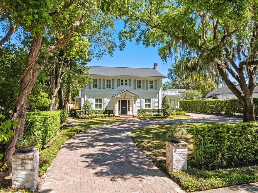 One of Winter Park’s iconic and cherished homes, just a short distance from Park Avenue. On one of the most picturesque, brick-lined streets in downtown Winter Park, this extraordinary residence is a rare opportunity to own a piece of the city’s rich architectural history, fully reimagined with modern elegance and thoughtful design. On the same city block as the Alfond Inn and a two-block stroll to the world-renowned Park Avenue, this home offers not only luxurious living but an unparalleled lifestyle in one of Central Florida’s sought-after communities. Park Avenue is the heartbeat of Winter Park, a tree-lined promenade brimming with charm, home to award-winning restaurants, boutique shopping, art galleries and cultural landmarks. Residents and visitors alike are drawn to its timeless ambiance, where the rhythm of the day flows from morning coffee at a corner café to evening dinners under twinkling lights. Whether enjoying “Movies in the Park,” seasonal art festivals, the lively Winter Park Farmers’ Market or beloved holiday parades, living here means having a front-row seat to all of Winter Park’s treasured traditions. Originally built in the 1930s, this five-bedroom, 5.5-bath home has been meticulously renovated in recent years to preserve its historic character while seamlessly incorporating every modern convenience. From the moment you enter, you’re greeted by gleaming hardwood floors, classic architectural details and a warm, inviting atmosphere. The gracious living room centers around a charming fireplace, flanked by two sets of French doors that lead to a cozy sunroom, ideal for morning coffee or afternoon reading. A formal dining room provides an elegant setting for entertaining, while the open-concept kitchen and family room encompass a blend of functionality and style. The kitchen is a showpiece, featuring a large 15-foot Soma quartz island and countertops and marble backsplash, handcrafted cabinetry, top-of-the-line Wolf and Sub-Zero appliances, and a custom wet bar with under-counter wine refrigerator. It’s a space designed for gatherings, large or small. The expansive and private primary suite is on the main level and features a walk-in closet with custom built-ins and a luxurious en-suite bath with dual sinks and a marble/glass shower. Upstairs, you’ll find three additional bedroom suites, including one that could easily serve as a second primary suite, complete with French doors leading to a covered balcony. Each bedroom offers its own en-suite bath, hardwood floors and thoughtfully designed closet space with built-ins. A spacious first-floor laundry room offers ample storage, while the detached two-car garage includes a beautifully renovated first-floor guest cottage. Complete with a kitchenette, full bath, and cedar-lined walk-in closet, it’s the ideal space for guests, a home office or extended family. Surrounded by lush landscaping and a charming circular driveway, this home radiates curb appeal and classic Winter Park style. Whether you're walking to Park Avenue for dinner, enjoying a leisurely afternoon in Central Park, or simply soaking in the historic beauty of your neighborhood, this home places you at the center of it all. This is more than just a home, it’s a lifestyle and a rare chance to own one of Winter Park’s rare downtown area treasured properties.