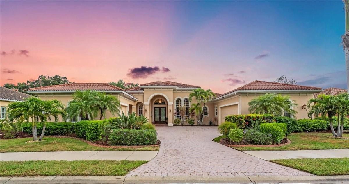 Welcome to a refined sanctuary of elegance and tranquility—this custom-designed estate by renowned builder John Cannon offers the ultimate in Florida waterfront luxury. Perfectly positioned in the highly sought after community of Walker's Cove, on a private cul-de-sac along the serene Braden River, this exquisite residence captures sweeping water views and direct access for boating or quiet moments dockside.
With 3 spacious bedrooms, 3.5 bathrooms, a private office, and a den, this thoughtfully designed floorplan combines grand scale with intimate comfort. For the automotive enthusiast, a generous brick-paver driveway leads to both a two-car and single-car garage, offering form, function, and timeless curb appeal.
Step through the grand entryway and be captivated by 20-foot ceilings, Palisade palm ceiling fans, and custom light fixtures that set a tone of understated opulence. Zero-corner pocket sliders dissolve the line between indoors and out, filling the home with natural light and inviting you to savor sweeping riverfront vistas from nearly every room.
The gourmet kitchen is a culinary dream, anchored by a Thermador 5-burner gas cooktop, hidden integrated refrigerator, and rich custom cabinetry. Overlooking the living space and lush backyard, the aquarium glass window in the dining nook offers a picture-perfect frame of the private pool and garden beyond.
The owner’s retreat is a peaceful escape with its own climate control, dual walk-in closets, and a spa-like bath featuring a soaking tub, walk-through glass shower, and a secret garden view—an indulgent hideaway within your home.
Designed for entertaining, the split floorplan includes a guest wing with a den and wet bar, while outside, the resort-style terrace awaits. Enjoy a dip in the heated pool or six-person spa, fire up the grill, or unwind beneath the stars on the illuminated boat dock, where mornings begin with coffee over the water and evenings end with a toast to the good life.
Built with enduring quality and peace of mind—hurricane-impact windows, updated HVAC systems under warranty, and recent upgrades to the pool heater and pump—this home is truly move-in ready.
Located just minutes from Lakewood Ranch, Sarasota’s world-class beaches, UTC Mall, and I-75, this home in the exclusive gated enclave of Walker’s Cove offers not just a residence, but a lifestyle of distinction.