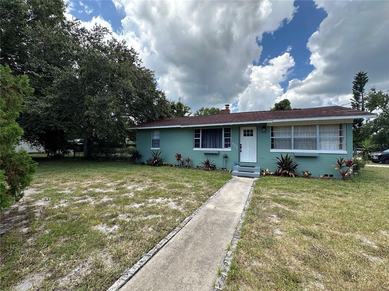 RENOVATED AND CHARMING CONCRETE BLOCK HOME ON A LARGE CORNER LOT! This beautifully updated property is perfect for first-time homebuyers or those seeking the ideal retirement retreat. Light and bright with plenty of windows, the home features a range of renovations and modern touches throughout. Enjoy the outdoors on the spacious, newly refreshed covered patio. The oversized 100' x 122' lot offers plenty of room for RV or boat parking and includes a fully fenced backyard. No HOA! Conveniently located just minutes from the beach, boat launch, parks, schools, shopping, and dining.