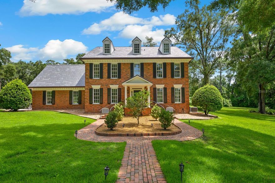Timeless Luxury in the Heart of Gainesville — Inspired by the Davenport House!
Welcome to this breathtaking three-story luxury estate nestled on just under 10 private acres in the charming town of Gainesville. Perched at the top of a rolling hill and inspired by the iconic architecture of the Davenport Mansion, this one-of-a-kind home offers elegance, character, and space designed for both entertaining and peaceful living.
From the moment you turn onto the long, winding driveway, you're greeted with a sense of grandeur. A beautiful flow through the grand entrance with spacious rooms open and bright with so much natural light. The gorgeous kitchen has it all- Viking appliances, marble finishes, with beautiful views. The home boasts 4 spacious bedrooms and 3 full bathrooms on the second floor, with thoughtful design details throughout. On the third floor, a fully functioning apartment studio offers the perfect retreat for guests, extended family, or creative studio space with living room, a fully updated bathroom. 
A separate, oversized 3-car garage includes its own beautiful and fully equipped studio apartment upstairs— ideal for additional income or private quarters. Outdoors, enjoy the resort-style brick paver pool deck with oversized cabana bar, complete with TV, wet bar, and grilling area — perfect for hosting unforgettable Saturday barbecues with friends and family. For equestrian enthusiasts, the property features a sectioned pasture with fencing, ready for horses. Inside and out, this home is filled with charm and modern comforts — creating the perfect blend of classic design and contemporary ease. Whether you're looking for a forever family estate, a private retreat, or a showpiece for entertaining, this remarkable property offers the privacy, space, and timeless style you've been searching for.