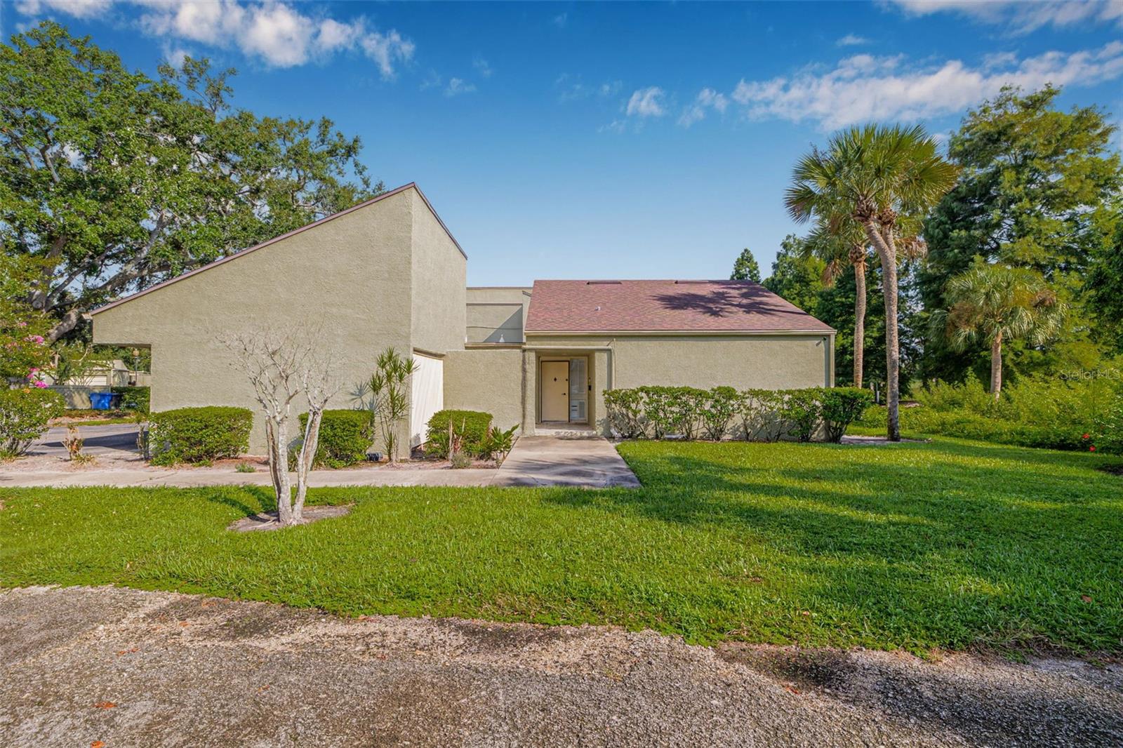 This Carrollwood Village single-story end-unit condo offers peaceful golf course and pond views, and features a two-car carport, interior laundry, and a sunroom. As you step through the front courtyard and into the home, you're welcomed by an open floor plan with natural light and views extending through the sunroom to the green space beyond. The kitchen has been updated with wood cabinets, granite countertops, and NEW stainless-steel appliances (2025), and includes a cozy breakfast bar and a window overlooking the courtyard — perfect for gardening. Adjacent to the kitchen is a small storage room with access to the carport, and an interior laundry room that offers plenty of space. The dining area looks out over another small courtyard, providing a quiet nook for plants or outdoor decor. The bedroom is spacious, with generous closet space and sliding doors to access to the sunroom, which leads directly to the back of the condo and overlooks the golf course. The bathroom features a walk-in shower and granite countertop. Located in a well-maintained community, this home is close to shopping, dining, and neighborhood parks. Nearby conveniences include Publix, Panera Bread, Marlow’s Tavern, and Carrollwood Village Park. This is a great opportunity to own a home in Carrollwood Village!
