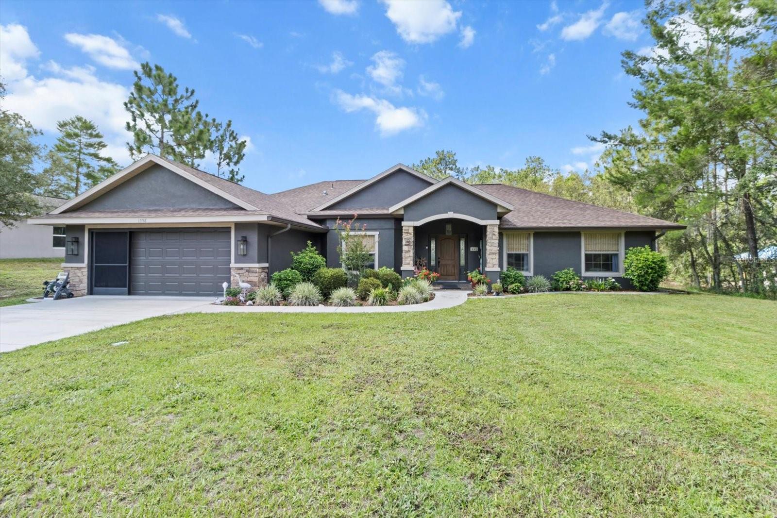 Updated Citrus Hills Gem on Nearly an Acre – No HOA! Welcome to this beautifully maintained 3-bedroom, 2-bath home nestled on a spacious .96-acre lot in a peaceful, well-kept neighborhood of Citrus Hills. With no HOA and no deed restrictions, you’ll enjoy the freedom to live the lifestyle you choose. Step inside to discover an updated interior featuring wood-look porcelain tile and luxury vinyl plank flooring throughout. The heart of the home is the custom-designed kitchen, complete with rich wood cabinetry, high-end stainless steel appliances, a stylish custom oven vent (that vents to the exterior), and a stunning designer wood & stone bar that surrounds the kitchen—creating the perfect space for friends and family to gather. Both bathrooms have been tastefully updated with thoughtful custom finishes. Fresh exterior paint enhances the home’s inviting curb appeal, highlighted by a welcoming entryway and manicured landscaping. The backyard retreat is ideal for entertaining! Enjoy a pavered patio with a gazebo for grilling and relaxing, plus a fire pit, mature landscaping, and high-end fencing that provides beauty and security for pets. As a bonus, the sellers are including a 1-year home warranty with an acceptable offer, giving you peace of mind. Don’t miss your chance to own this move-in-ready home in a highly desirable location with space, custom upgrades, and charm!