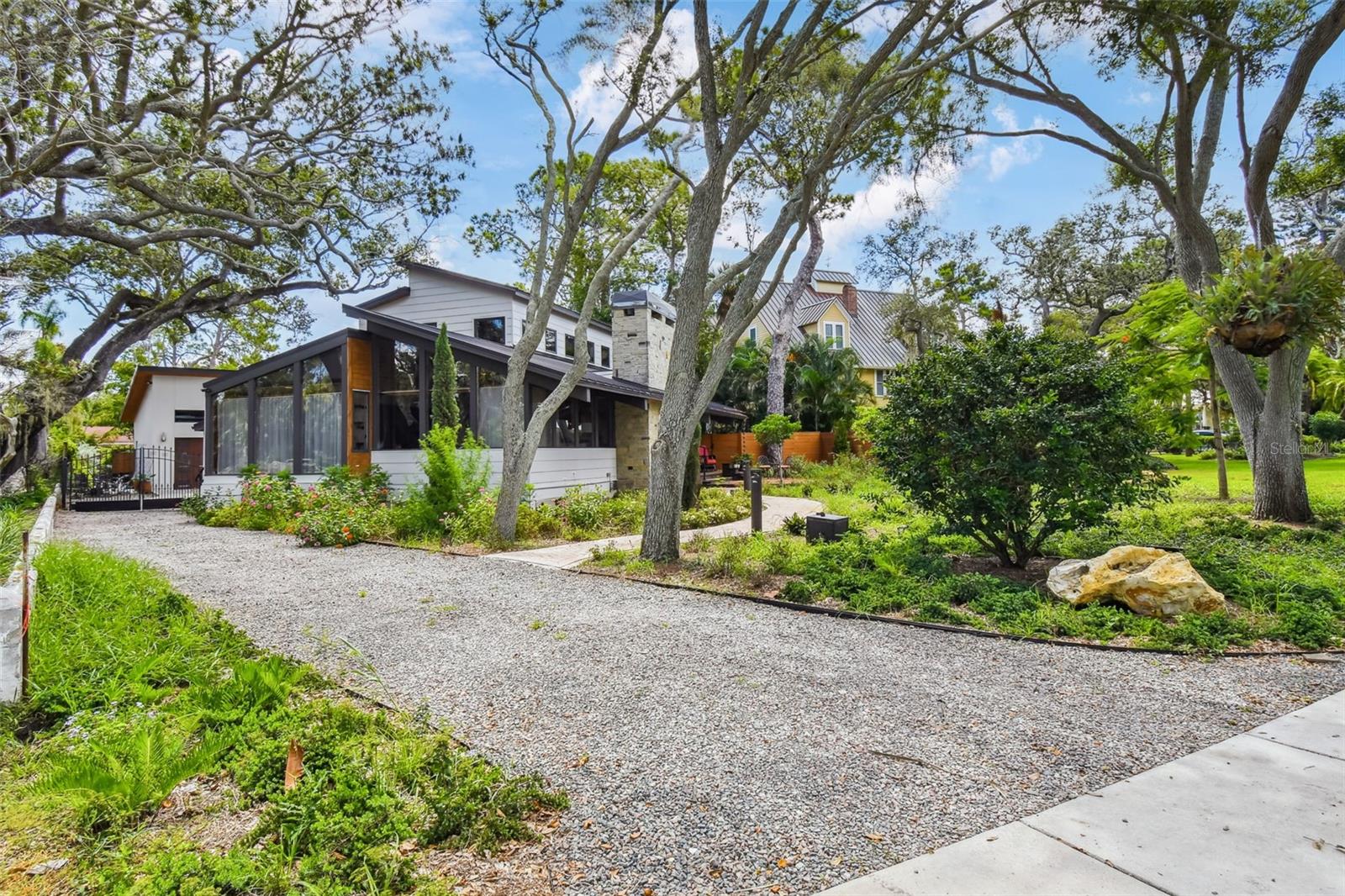 A rare opportunity to own an incredible waterfront residence on the most coveted street in Dunedin, just steps from downtown. Across the wide open waters of St Joseph Sound to Caladesi Island, this perfect mid-century modern home has been completely remodeled with taste, high-end design and luxury finishes. 2nd floor as well as the 1,250 sf garage are recent additions to the home. The custom European kitchen, the solid black walnut floors, full-length monolithic laminated glass widows, precious oak-shaded courtyard, incredible floating staircase, 2 large master suites are just but a few of the attributes that make this home an actual treasure. Every corner of this home offers a different design element or finish thats been thoughtfully selected and perfectly executed; including a secret door disguised as a book case into a possible office or a 3rd bedroom. This historic location, just steps from all the amenities downtown Dunedin has to offer, provides a uniquely tranquil and private lifestyle with breathtaking sunsets. Couple it with this jewelry box of a home, and all one can say is: PARADISE FOUND!