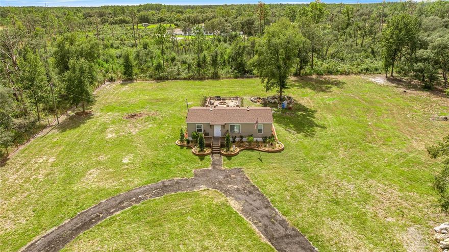 BRAND NEW ROOF and HVAC 2025! Country Living, Redefined! Fully renovated with modern upgrades throughout. Short distance from Hwy 200, local amenities, schools, medical, shopping, dining, parks and recreation. Featuring; 3 Bed/2 Bath Double Wide Home nestled on 2½ acres high and dry. Split floor plan, volume ceiling, luxury vinyl flooring, high-efficiency windows, inside laundry, front & rear porch, and perimeter fenced. Updated and open kitchen features new shaker cabinets and new appliances. Bathrooms offer sleek, updated walk-in showers, vanities, and fixtures. The brick paver patio with fireplace provides a charming outdoor retreat. Expansive private yard—perfect for family fun, entertaining guests, and furry friends to roam freely. Bring your horses, goats and chickens or cultivate crops! Your dream mini farm awaits away from it all but close to everything! Upgrades include; NEW Roof, Central A/C, Tankless Water Heater, Water Softener, Plumbing, Electrical, Drywall/Texture, Insulation, Windows, Cabinetry, Flooring, Front & Rear Porch, Paver Patio, Vinyl Siding, Skirting, Rain Gutters, Driveway, Fence, Landscaping, Well Pump and Septic. Don't miss your chance, schedule a viewing today and make this your forever home. NO HOA, NO Flood Zone!