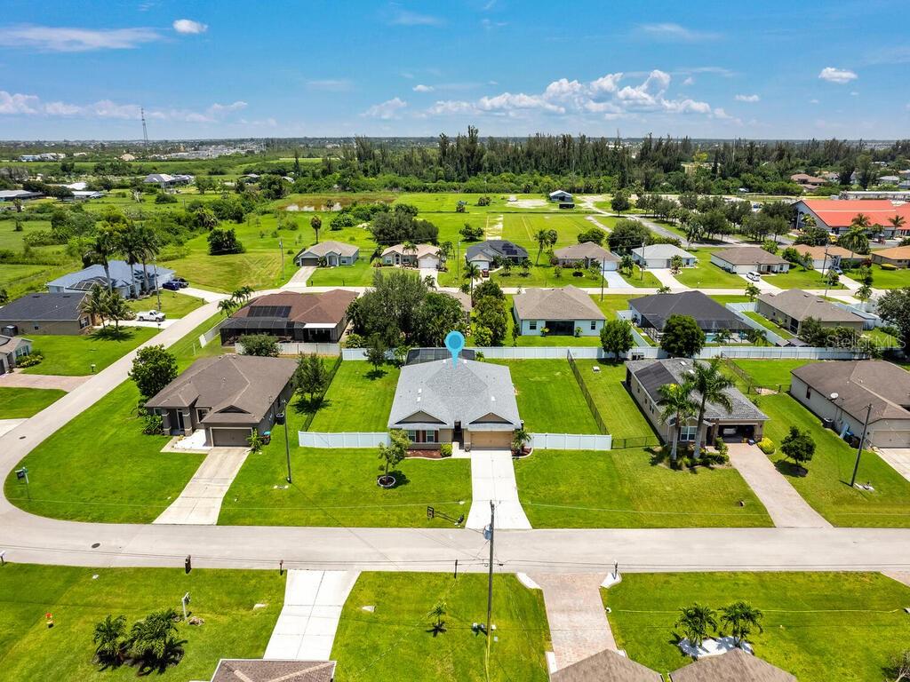 Welcome to this beautifully updated pool home offering space, style, and privacy on a rare triple lot in the heart of Cape Coral. Built in 2017, this 4-bedroom, 2-bathroom residence blends modern upgrades with thoughtful design, providing a comfortable and turnkey living experience. Step inside to discover a freshly painted interior with a bright, open layout, tile flooring in the main living areas, and luxury vinyl plank in the spacious primary suite. The newly remodeled kitchen is the centerpiece of the home, featuring crisp white shaker cabinets, quartz countertops, and brand-new stainless steel appliances—perfect for cooking, entertaining, or simply gathering with family and friends. Both bathrooms have also been tastefully refreshed with new vanities and countertops. The guest bath includes a convenient tub/shower combo, while the oversized primary suite offers a massive walk-in closet and plenty of natural light. Generous storage throughout the home, including four dedicated linen and storage closets. Step outside to your private backyard oasis, complete with an extended paver pool deck and a sparkling pool—ideal for soaking up the Florida sun, hosting weekend BBQs, or unwinding after a long day. The fully fenced yard offers peace and seclusion, with plenty of room for pets, play, or future enhancements. A BRAND NEW ROOF adds value and peace of mind, while the 2-car garage ensures ample storage. Located within walking and biking distance to parks, schools, and local churches, and just minutes from shopping, dining, and the vibrant, artsy fishing village of Matlacha, this home offers the perfect balance of convenience and charm. Don't miss this opportunity to own a move-in-ready home on an oversized lot in one of Cape Coral’s most desirable areas!