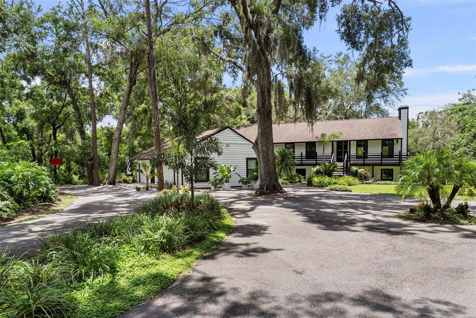 A rare opportunity to own a fully renovated estate featuring a beautifully remodeled 3-bedroom guest house, resort-style pool, and tranquil pond frontage—all just 15 minutes from Downtown Tampa. Blending modern upgrades with timeless architectural elements, this expansive property offers a luxurious and functional lifestyle with no expense spared in its 2024–2025 transformation.
Both the main house and guest house have been freshly painted inside and out, creating a clean, cohesive look. The detached guest house is perfect for visitors, extended family, or potential rental income, with new interior paint, modern lighting and ceiling fans, updated switches and outlets, a new high-efficiency AC system, Thermador dishwasher, and a newly tiled front deck. Exterior solar lighting adds charm and functionality.
The main residence features newly installed white oak hardwood flooring, raised ceilings with spray foam insulation, and all-new drywall. The chef’s kitchen is outfitted with custom cabinetry, premium Thermador appliances including an induction cooktop, dimmer switches, USB-A/C outlets, and designer lighting.
A newly added master suite offers a custom-designed closet system and private en-suite bath. In total, the home includes four fully renovated spa-style bathrooms, each featuring LED-lit mirrors, Jacuzzi and soaking tubs, jet showers with LED temperature lighting, tray ceilings with ambient LED lighting, and designer sconces.
Upgrades throughout include two heavy-duty iron front doors, 16 new interior doors with updated hardware, two electrical panels with added circuits, and a high-performance Rheem 18V tankless water heater. The home also has two brand-new AC systems and air handlers, high-end Softlite Energy Star-rated triple-pane hurricane-impact windows, spray foam insulation, and exterior keypad entry locks.
Both the main house and guest house are equipped with a comprehensive security system covering all windows and doors for enhanced peace of mind.
The backyard has been redesigned to create a serene retreat. The pool area includes a newly framed and tiled deck with two tiled steps, tropical landscaping, decorative rocks, solar lighting, and freshly painted brick surfaces. A new pool pump ensures year-round enjoyment. The upgraded irrigation system features new plumbing, an 8-zone sprinkler system, and a dedicated well with a new tank.
Additional exterior enhancements include modern aluminum deck railings, pavers for the garbage area, and fresh exterior paint on both structures.
Conveniently located near I-75 and I-4 and just minutes from Tampa International Airport, this extraordinary property offers privacy, comfort, and an unmatched lifestyle. Whether hosting guests or enjoying peaceful evenings by the pond, this estate is a true gem in the heart of Florida living.