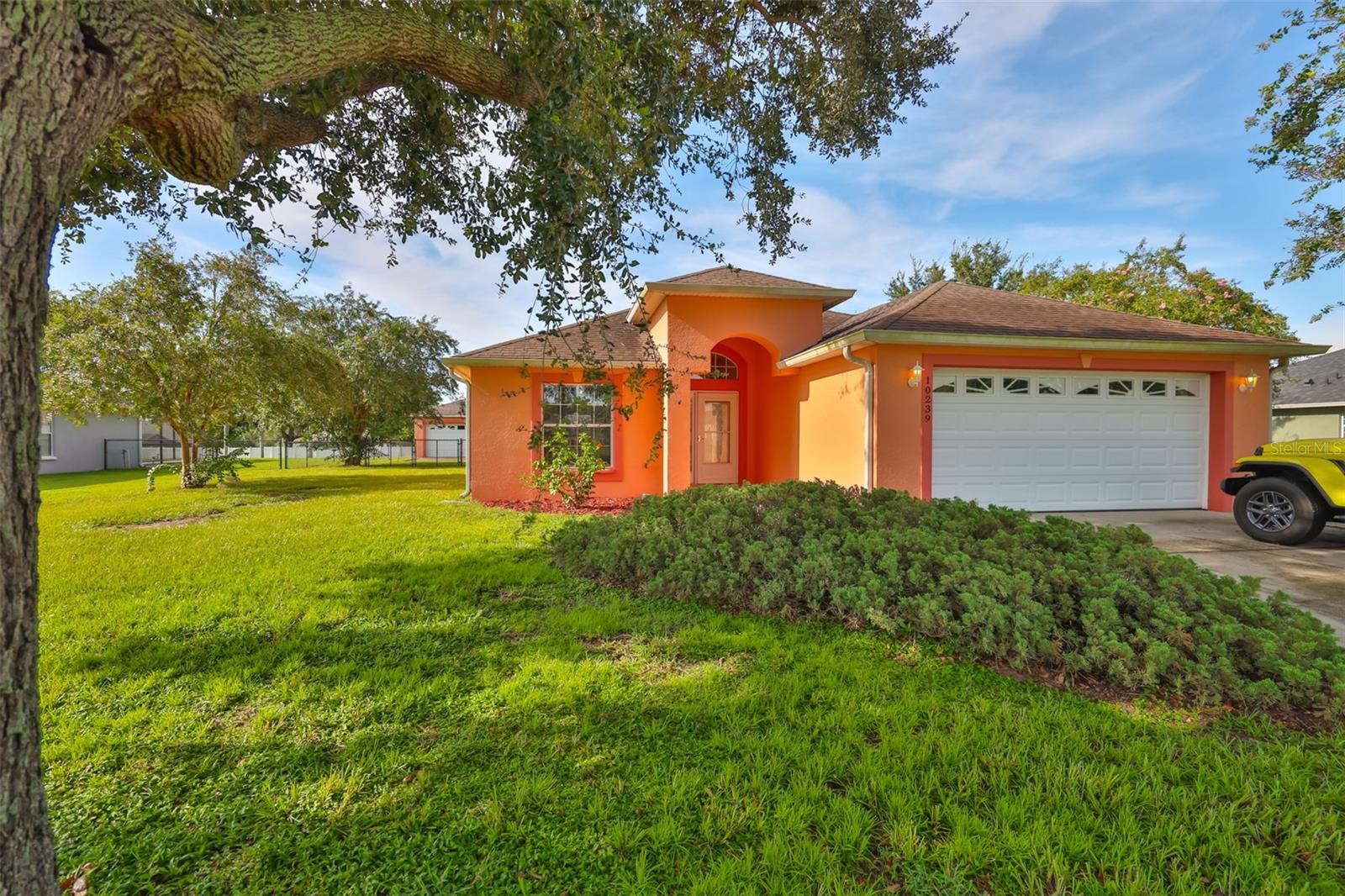 Beautiful 3-Bedroom Home on Half-Acre in Desirable Centennial Estates! Welcome to this spacious 3-bedroom, 2-bath home located in the sought-after community of Centennial Estates one of Dade City's best-kept secrets. Situated on a large, fully fenced ½-acre lot, this property offers privacy, space, and endless possibilities, including a detached additional garage perfect for storage, hobbies, or extra parking. Inside, the home features a split-bedroom floor plan with a bright and open living room that includes built-in shelving. French doors lead out to a large screened lanai, complete with a built-in bar and outdoor shower - perfect for entertaining or relaxing in the Florida breeze. The kitchen is a delight with ample cabinet space, generous countertops, and a breakfast bar. An indoor utility room adds extra convenience. The primary suite boasts a spacious bathroom with double sinks, a walk-in shower, and a jetted soaking tub. The expansive backyard is ideal for gatherings, pets, or even a future pool. Schedule your showing today!