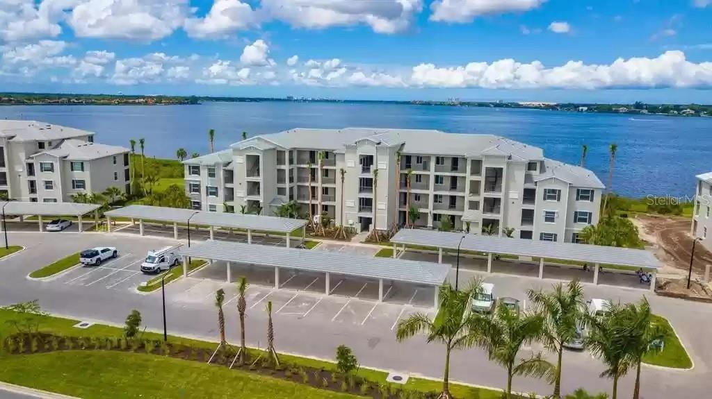 Luxury Riverfront Condo in Tidewater Preserve. Enjoy breathtaking nightly sunsets and watch boats glide by from your beautifully upgraded fourth-floor condo in building 2, located in Bradenton’s premier riverfront boating community—Tidewater Preserve. This 2-bedroom, 2-bath Arbor model is thoughtfully designed for both comfort and style, with premium upgrades throughout. The Alexa-enabled smart home features hurricane-impact windows, crown molding, and tile flooring in the main living areas, with carpet in the bedrooms. The kitchen is a true showpiece, offering shaker-style cabinetry, stainless steel appliances, and a spacious one-level quartz island, ideal for entertaining or everyday living. Smart-home enhancements include a Ring doorbell system, coded keyless entry, and a smart thermostat, all designed to add convenience and peace of mind. Step out onto the private screened lanai and take in peaceful, unobstructed views of the Manatee River—a perfect place to enjoy your morning coffee or unwind at the end of the day. This condo also includes an assigned covered parking space and a private storage unit for added convenience. Tidewater Preserve offers more than just a home—it’s a lifestyle. Residents enjoy access to a private marina, three resort-style pools, two fitness centers, tennis courts, a dog park, playground, kayak launch, and scenic walking trails along the riverfront.