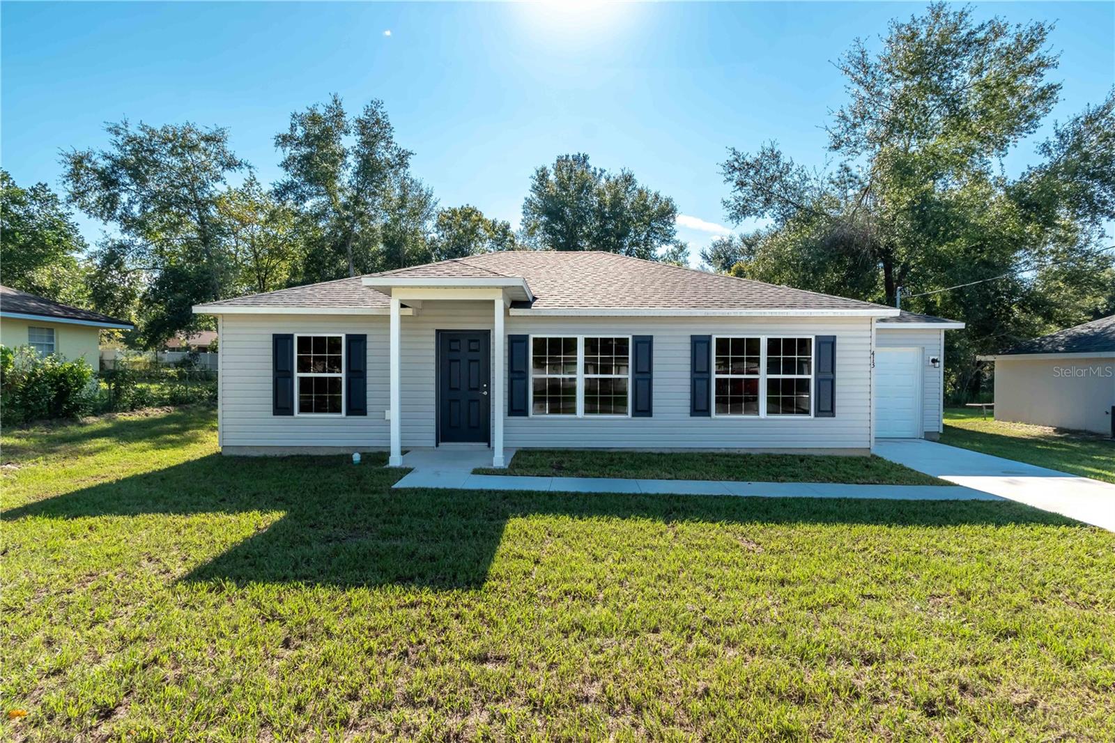 Under Construction. Charming Cottage Home with Modern Comforts, No HOA, and a 10 Year Warranty! Home will be ready for you to move in within 30 days! • Huge, Open Kitchen: The heart of this home boasts an expansive kitchen with a remarkable 7-foot-long pony-top bar. Enjoy an abundance of counter space, perfect for all your culinary adventures. • Split Floorplan: Designed for privacy and comfort. • Wonderful Master Suite: Retreat to your spacious master bedroom featuring a large walk-in closet for ample storage. The luxurious en-suite bathroom is a true sanctuary with extensive cabinet space, two vanity sinks, and a Roman-style walk-in tiled shower. • Energy Efficient: Enjoy lower utility bills and year-round comfort thanks to added insulation throughout the home. • Expansive Backyard: The large backyard offers endless possibilities! With plenty of room for a future swimming pool, a playset, or a lush garden. Community allows for fencing & boat/rv parking on property. • No HOA Dues! • Effortless Commutes: Easy access to Ocala, The Villages, Lake Weir, and Belleview. • Nature at Your Doorstep: Explore the beautiful springs of the Ocala National Forest, just a short drive away. • Weekend Getaways: Only an hour's drive to the vibrant city of Orlando or the stunning Florida beaches, perfect for weekend escapes. • Don't miss this opportunity to own a charming home with so much to offer in a fantastic location!