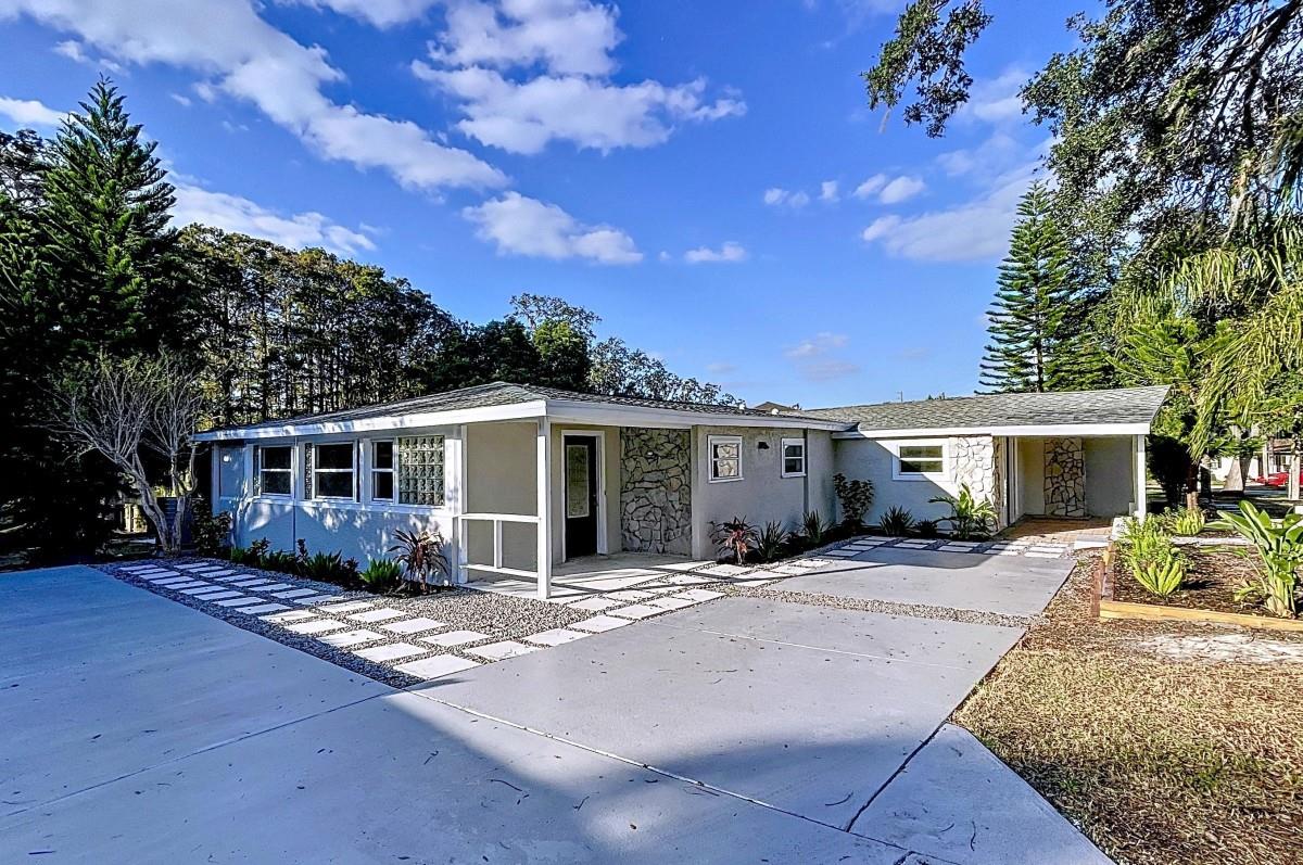 Welcome to an exquisitely remodeled lakefront sanctuary nestled in the sought-after Bass Lake Estates of New Port Richey. This 4-bedroom, 4-bathroom home, with 2 bonus rooms that could serve as a home office, gym, formal dining room, or anything else you envision, offers endless possibilities for both personal enjoyment and income potential. With 2,379 square feet of meticulously updated living space, set on a 0.39-acre lot with 35 feet of pristine lakefront on Lake Worrell. Built on an incline above the lake, the home is protected from flooding and offers both breathtaking water views and direct lake access, making it the ideal getaway for vacationers or a peaceful home for year round living. Whether you're looking for a personal sanctuary or seeking to capitalize on the thriving short-term rental market, this home has everything you need. Every element of this property has been thoughtfully redesigned, with all systems either brand new or recently upgraded, providing peace of mind for the new owner or potential short-term guests. The open-concept interior showcases a contemporary aesthetic, featuring ceramic tile flooring, sleek quartz countertops, and high-end stainless-steel appliances in the chef-inspired kitchen. The expansive primary suite includes a spacious walk-in closet and a luxurious en-suite bathroom, while the large living and dining areas provide a seamless flow for both daily living and entertaining. Step outside to your own private dock for lake access.