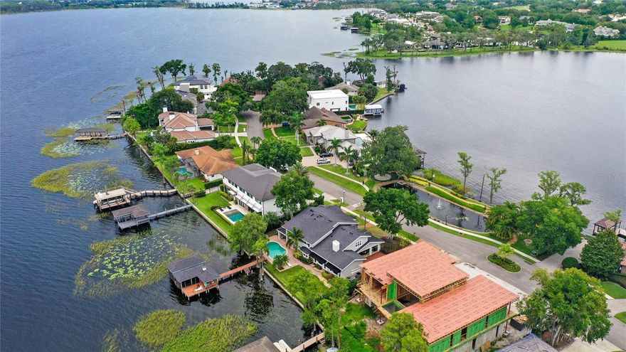 Under contract-accepting backup offers. Perfectly positioned on the pristine Butler Chain of Lakes, this lakefront home in the exclusive gated enclave of Bay Point at Bay Hill, offers a rare blend of elegance, comfort, and breathtaking views. As you drive down the peninsula, you're flanked by water views on both sides. Enjoy nightly Disney fireworks on the horizon, and golden sunsets that make every evening unforgettable. Inside, you're greeted with a traditional layout, wide-plank wood flooring, statement fireplace, and detailed ceiling treatments that create a warm, refined atmosphere. A private office offers the ideal space for remote work or study. The open family room, framed by beamed ceilings and custom-built-ins, takes full advantage of the panoramic lake views, with natural light pouring in through oversized windows and glass doors. The gourmet kitchen is outfitted with custom cabinetry, high-end appliances, an oversized pantry, and solid surface counters that elevate everyday living and entertaining. Step outside to your personal resort. A large covered lanai with a full summer kitchen (grill, fridge, and prep space) opens to a sparkling pool and lush lawn that leads directly to your private boat dock with lift on Lake Tibet. Whether hosting friends or enjoying a quiet moment on the water, this backyard delivers. The downstairs also features a versatile game/play room for added living space. Upstairs you'll find four full en suites. The owner’s suite is a true retreat with a private sitting area, balcony overlooking the lake, and a spa-style bath with a soaking tub, steam shower, dual vanities, and custom cabinetry. Call today for a private tour!