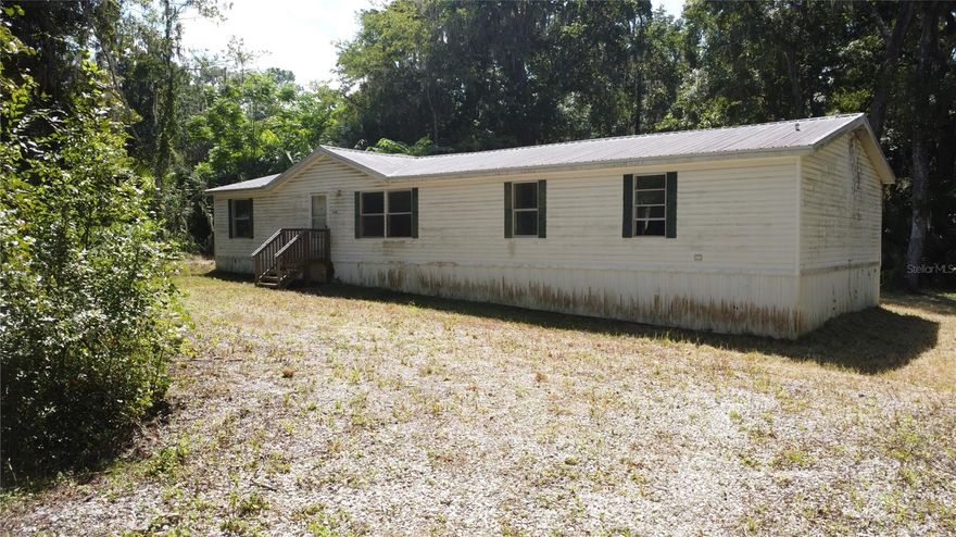 Fixer-Upper with Big Potential – 1.16 Acres in SW Ocala!
Looking for your next investment property or renovation project? This 4 bed, 2 bath home (built in 2001) offers 1,848 sqft and sits on a 1.16-acre lot—ready for someone with vision. The home needs repairs throughout, including new sheetrock and possible mold remediation in the back hallway. Roof, HVAC, and water heater are original. That said, there’s already been progress: the 0.25-acre homesite has been cleared, a new driveway apron added, and there’s a brand-new unused septic, plus water and power already on site. With the right updates, this property could shine again. Sold as-is—bring your contractor and your imagination!