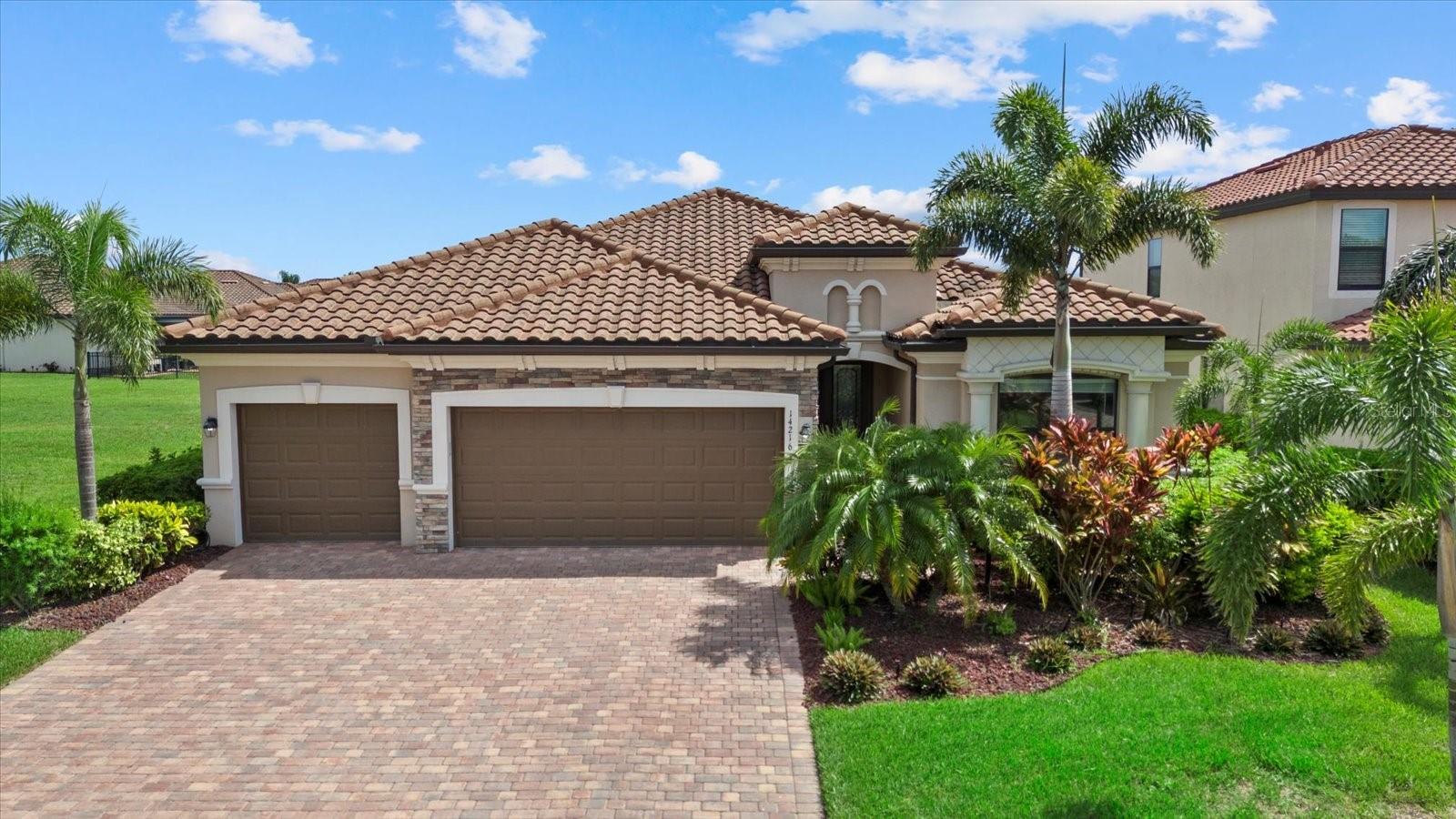 Welcome to the Beautifully Appointed Lennar Princeton II in Savanna at Lakewood Ranch. This highly desirable model offers the perfect blend of comfort, design, and functionality. With 4 bedrooms and 2 baths arranged as a split floor plan, you’ll enjoy privacy and quiet separation between the primary suite and guest rooms, ideal for families or hosting visitors. The modern kitchen features solid wood cabinetry, granite countertops, and a layout that’s perfect for preparing meals or entertaining guests. Elegant design details throughout the home include tray ceilings in the living room, architectural niches, and a formal dining space enhanced by classic columns, creating a
comfortable and inviting atmosphere. From the kitchen and breakfast nook, your view opens up to the sparkling pool, large paver patio, and screened lanai, all set against a backdrop of gleaming lake views and breathtaking tropical sunsets. As you arrive, the stacked stone accents on the upgraded front elevation, along with the three-car garage, immediately make a strong impression. The approach to the home is equally appealing, with lush landscaping and a perfectly manicured lawn—all maintained by the community for low-maintenance living. Located in the gated neighborhood of Savanna at Lakewood Ranch, you’ll be just minutes from everything this vibrant master-planned community has to offer—including Waterside, Lakewood Ranch Country Club, top-rated schools, and everyday conveniences. This newer construction home provides added peace of mind, knowing the structural and mechanical components are in excellent condition. Don’t miss this opportunity to own a piece of paradise in one of the most sought-after neighborhoods in Lakewood Ranch. Schedule your private showing today.