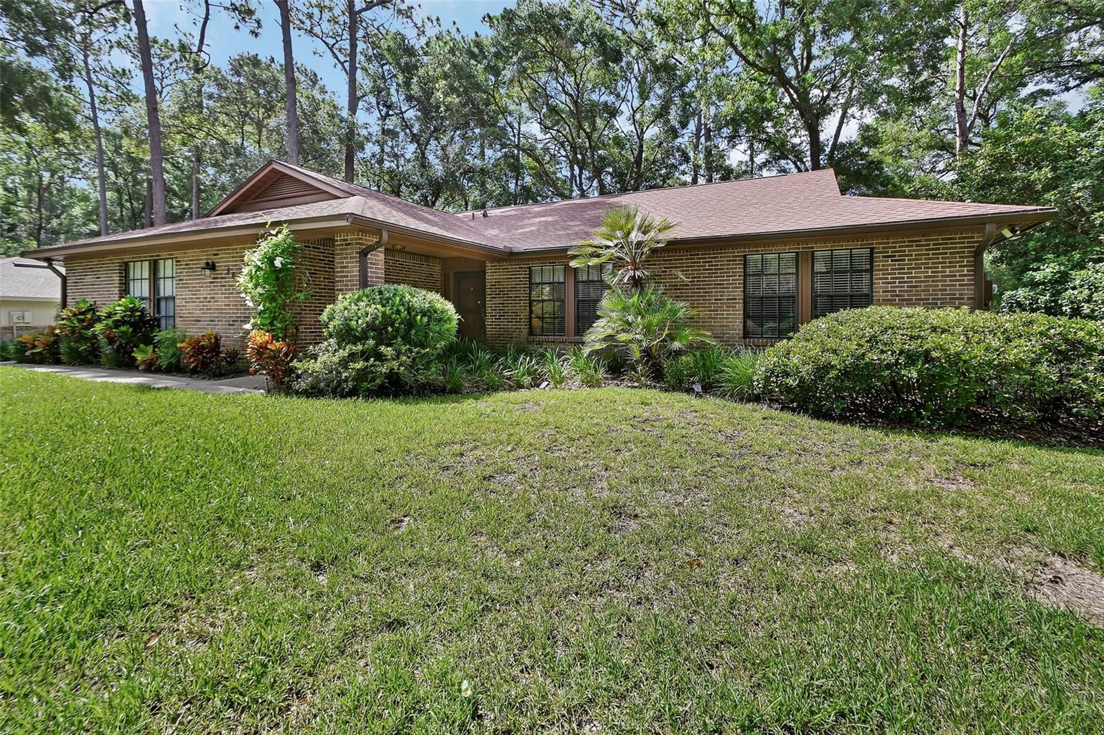 LONGLEAF PLANTATION: Move-in ready and beautifully maintained with pride of ownership| ROOF 2023 | AC 2024 | 3-BEDROOM, 2.5 BATHROOM home sits high on a spacious .52-ACRE LOT with beautiful views. Inside, the LIVING ROOM offers decorative WOOD BEAMS and LARGE WOOD BURNING FIREPLACE. The KITCHEN is spacious with plenty of counter space including breakfast bar, wood cabinets and newer Stainless Steel appliances. The powder room / half bath is conveniently located for easy access. THE PRIMARY BEDROOM is GENEROUSLY SIZED and offers ample closet space. You will enjoy the Florida Room that serves as a wonderful flex space for an office or playroom. An oversized garage provides wonderful storage and parking. The property has a well for irrigation while the home gets City drinking water. This home also benefits from a LOW OPTIONAL HOA and a PRIME LOCATION close to SHOPPING, DINING, and QUICK ACCESS TO I-4. A perfect blend of STYLE, FUNCTION, and LOCATION in one of DELAND’S MOST LOVED NEIGHBORHOODS