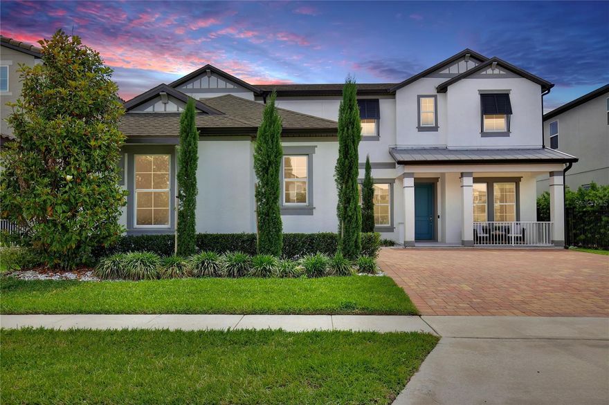 Welcome to 10139 Austrina Oak Loop!  Featuring SIX BEDROOMS PLUS OFFICE and FIVE FULL BATHS, on a premium one-third acre lot overlooking the Disney preserve with a HEATED SALTWATER POOL AND SPA under a screen enclosure, this beautifully upgraded home is 4,500 square feet of understated elegance.  With no front neighbor, step back to take in the impressive façade, paver drive and custom landscaping.  Across the foyer from the formal dining room, French doors lead to the private office / seventh bedroom with an adjoining full bath.  The gourmet kitchen and butler’s pantry feature quartz countertops, stainless appliances including double ovens, 42-inch cabinets with bonus overhead cabinets, an oversized island, and a walk-in pantry, all under the glow of custom light fixtures. A triple-pane sliding door with motorized blinds overlooks the pool and illuminates the family room, with ten-foot ceilings and luxury vinyl plank floor.  Around the corner is the first floor Owner’s Suite, with tray ceiling and separate pool access, plus a large Owner’s Bath with two quartz vanities, soaking tub with separate shower and a huge walk-in closet.  Upstairs, a wet bar with granite counter opens into a spacious loft with separate bonus room, adjacent to an en suite bedroom with full bath and walk-in closet.  A tour of the large secondary bedrooms reveals plentiful natural light, walk-in closets, and views of the pool and wooded area beyond. Outside, a paver deck surrounds the heated saltwater pool and spa – all enclosed in an oversized screen enclosure offering uninterrupted views of nature by day and Disney fireworks by night.  This immaculately maintained is completely move-in ready with custom window treatments, fully fenced lot, rain gutters and much more. This home is walking distance to top rated schools, retail, and dining at The Mark, and offers easy access to area attractions and the FL-429 corridor. Contact us now to schedule a private showing of this beautiful home!