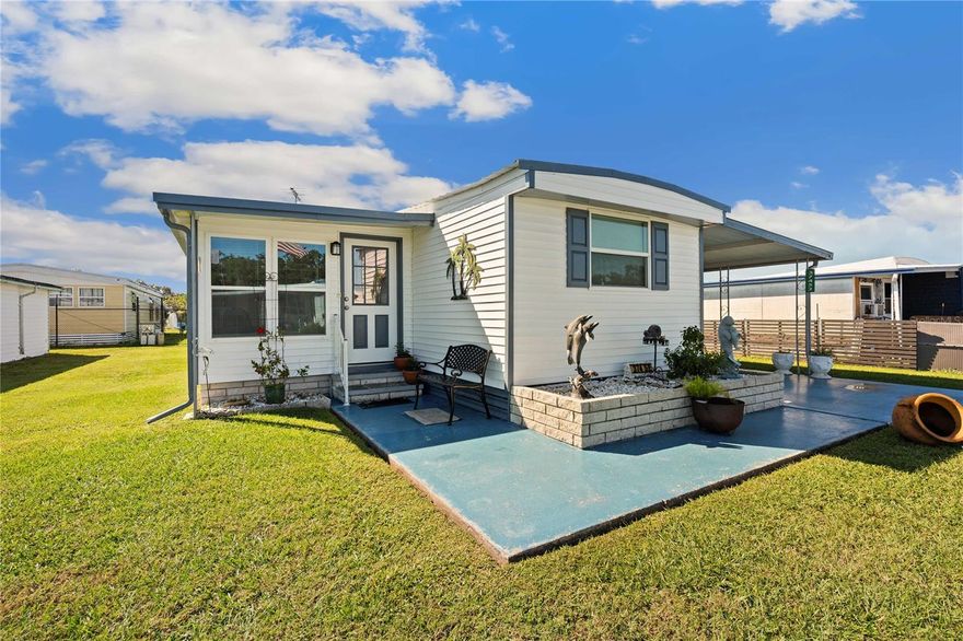 Are you searching for a move-in ready Florida home with no monthly fees and no work needed? Look no further—you’ve found 37452 Attica Avenue! From the moment you pull into the driveway, you’ll notice the meticulous care and pride of ownership throughout this property. The beautifully maintained landscaping and great curb appeal set the tone for what’s inside. This spacious home is larger than many doublewides and features numerous updates. The renovated Florida room has newly insulated walls and ceiling, stunning Carrara marble tile flooring, and is fully heated and cooled for year-round comfort. The kitchen offers updated oak cabinetry, tile flooring, and an open concept that flows easily into the dining and living areas. Prefer to use the Florida room as your living room? This flexible layout allows you to reimagine the living room space as a formal dining area or additional seating area to relax. The guest bedroom at the front of the home fits a queen-size bed and includes its own half bath with tile flooring. The primary bedroom at the back connects to an adjoining room currently used as a third bedroom—a versatile space ideal for an office, hobby room, or even a future en-suite bath. The full bathroom has been beautifully updated with tile flooring, an oversized maple vanity, and a new walk-in shower. Off the hallway, you’ll find built-in pantry storage and access to the carport. The carport houses a newly enclosed storage area, a concrete bunker that doubles as laundry and storage space plus it has room for one vehicle. Other updates include a 2025 roof plus multiple new windows and doors. This home truly offers everything you need for your sunny Florida lifestyle—style, space, and peace of mind. Don’t let 37452 Attica Avenue slip away—schedule your showing today!