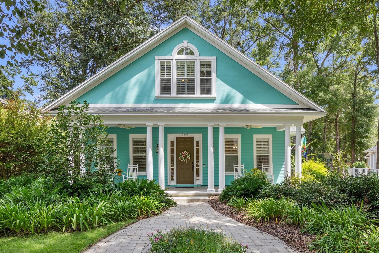 Welcome to this beautiful craftsman style home built by Dibros Design and Construction on an oversized lot in the heart of Town of Tioga. The home features 4 bedrooms and 3 bathrooms, 2,627 sqft of living space, a large picturesque yard, and a 2 car garage on a third of an acre! All of the living space along with three of the bedrooms, including the primary suite, are downstairs with a sizable bedroom suite and full bathroom upstairs. As you approach the home, you’ll appreciate the front yard and well-manicured landscaping, in addition to the architectural columns, newer roof (2022), durable hardiboard cement siding, and oversized front porch. The front door opens to a light and bright welcoming foyer with built-in bookshelves that face the dining room/flex space. You will love the decorative plantation shutters, crown molding, and the beautiful hardwood flooring throughout the main areas and in the bedrooms. Moving through the home, you will find the kitchen which features solid maple wood cabinets, granite counters, and stainless steel appliances, including a gas range, that are sure to serve any chef in the family. Enjoy a quick breakfast or a morning coffee in the breakfast room that overlooks the expansive side yard. The kitchen opens to the living room, which also features built-in shelves and a gas fireplace that you can enjoy on those cooler winter days. The primary bedroom is at the back of the home, and it boasts a sizable walk-in closet and an ensuite bathroom with tiled walk-in shower, double vanity, and a large jetted tub. The two other bedrooms are located towards the front of the home and both offer oversized built-in closets with additional storage cabinets above. These secondary bedrooms share a hall bathroom featuring a vanity and a tiled tub-shower combo. The oversized fourth bedroom is situated upstairs with two large closets, built-in desk and bookshelves, vaulted ceiling, and a separate bathroom with a pedestal sink and a tub-shower combo. Enjoy tons of natural light throughout the main living areas with several windows and a single door that leads out to the back porch off the living room. Relax on the spacious screened back porch on cool spring days or summer nights, and set up your grill on the paver patio while hosting friends and family for bbqs in the fully fenced backyard. Warm up by the firepit on those cooler winter days and make some smores and create everlasting memories. In spring and summer your garden will be bursting with color as flowers bloom in your front and back yards. The 2 car garage provides ample storage for your vehicles, a golf cart, or sports and yard equipment. You'll appreciate lower utility bills with Clay Electric service. Town of Tioga residents enjoy a community pool, playground, pickleball courts, tennis and basketball courts, and relaxing walking trails, as well as some of the best holiday decorations and holiday festivities around! This home is just a short walk from Tioga Town Center where you’ll find Blue Highway Pizza, Gainesville Health and Fitness, Local Provisions, festive holiday events, and much more! Tioga is within close proximity to Jonesville shopping center, HCA Florida North Florida Hospital, UF, and UF Health Shands. Schedule your private showing today!