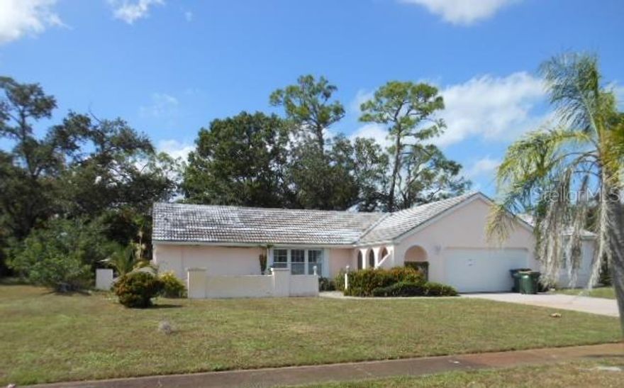 Spacious 3 bedroom, 2 bath home. If you don't need 3 bedrooms one is large enough for crafts or a game room, whatever your imagination desires. Combo living/dining room and family room as well as large lanai makes this a perfect home for entertaining or just large gatherings.  The kitchen is truly the heart of this home, located in the center of the layout. Park like back yard with some clean up. Property is located just minutes from US41 for access to all points north and south.  Take a look and make this house a home again!