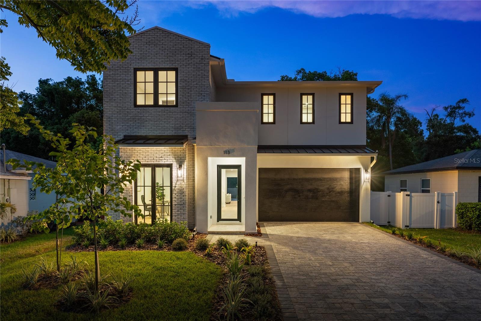 Exquisite new construction residence by esteemed luxury builder LUIH Homes, perfectly positioned in the heart of College Park. This architectural gem offers an extraordinary blend of refined elegance, masterful craftsmanship, and cutting-edge design for the most discerning buyer. The show-stopping chef’s kitchen is the heart of the home, equipped with a full suite of professional-grade Thermador appliances, custom European-style cabinetry, dramatic quartz countertops, and an expansive waterfall-edge island that doubles as a statement piece and gathering space. A walk-in pantry adds convenience and luxury, while the open-concept layout flows seamlessly into the formal dining area and living room, enhanced by soaring ceilings, designer lighting, and expansive glass sliders that bathe the space in natural light. The lavish primary suite is a private sanctuary, boasting a spa-inspired bathroom with a freestanding soaking tub, an oversized walk-in shower, dual vanities, and an expansive boutique-style walk-in closet with custom cabinetry and integrated LED lighting. Additional upgrades throughout the home include custom millwork and even a wet bar with a built-in wine refrigerator and shelving with led lighting. Outside, a resort-style retreat awaits, featuring a sparkling pool with a sun shelf, a spacious covered lanai perfect for alfresco dining, and a fully equipped summer kitchen. Perfectly located just steps from Edgewater Drive’s charming shops, upscale boutiques, and award-winning cafes, and only minutes from The Packing District’s exciting new dining and lifestyle options, this home represents the pinnacle of luxury urban living in one of Orlando’s most desirable neighborhoods.