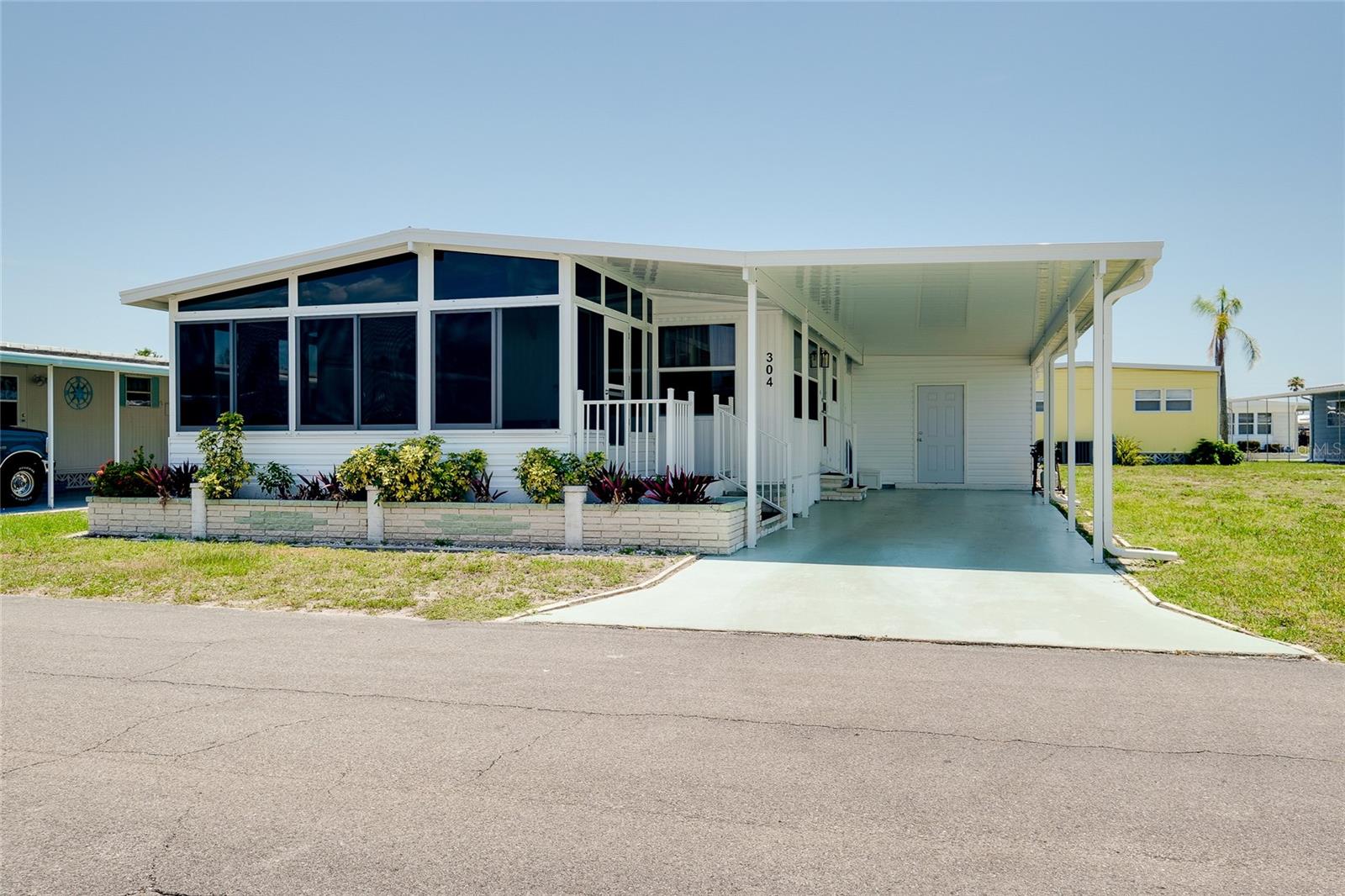 REDUCED PRICE Move-in ready beautifully maintained mobile home. 2 bedroom, 2 baths where you own your own land. Fully furnished with coastal theme. The home is 984 square feet of climate-controlled space. Enjoy your coffee in the spacious, bright and sunny Florida Room perfect for relaxing or entertaining year-round. The large primary bedroom includes two large closets providing ample extra storage. Outside you will love the large shed that includes a washer and dryer plus a workshop area ideal for hobbies, projects or extra storage. Located in a quiet friendly community, this home is perfect full-time residence 55+ or seasonal retreat. The park amenities are numerous and include 2 heated pools, 2 hot tubs, saunas, putt putt golf, a fitness center, tennis courts, bocce ball, corn hole, horseshoes, billiards, ping pong, game room, Tiki Hut, 2 Clubhouses, and free community bus transportation to local shops and outings. There are also numerous activities and social events for all community members to take part in. The low HOA fee includes Cable TV and Internet, Lawn Maintenance and all amenities. Located just minutes from downtown Venice and pristine beaches with easy access to shopping, dining, and entertainment options. Whether you are enjoying a sunset stroll on the beach or exploring the charm of downtown Venice, this location offers the best of Florida living.