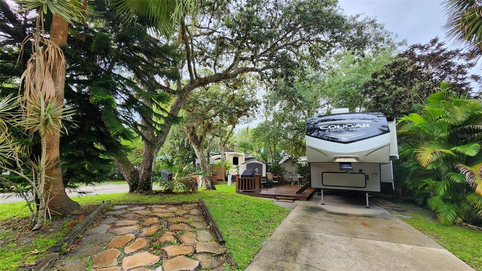 Turn Key!! Deeded RV Lot / RV Combo! Located in a great Resort in Central FL! WELCOME TO RIVER RANCH, Florida’s Luxury RV Resort with access to Lake Kissimmee! This Luxury RV Lot has a Turn-Key fully stocked 2bed/2ba RV in place and is generating income! This 2021 Keystone Cougar 32BHS will sleep up to 6! The master has a queen bed and its own half bath! The 2nd Bedroom has 4 twin bunk beds. There is a comfy sofa with recliners in the living room, along with a fireplace and large entertainment center. There is a dining table and the kitchen is fully stocked with everything you need! There is also an outdoor kitchen, grill and firepit for you to enjoy on the private patio! Perfect for families and couples traveling together! No golf cart included, however you can add one or guests can rent through the Office. River Ranch RV Resort is perfect for weekend vacations, family camping, seasonal living! River Ranch RV Resort offers beautiful landscaping and privately owned RV lots. There are many amenities such as Pools, Tennis, Pickle Ball, Clubhouse, Social Events, Billiards, Poker Room and more! ENTERTAINMENT AND FUN!! There are MANY fun things to do! For starters, there is a LIVE Rodeo every Saturday night – an excellent display of showmanship and fun for the entire family! There is even a Saloon (family friendly), with LIVE bands, DJs, dance parties and they give line dancing lessons for free. There is an adventure park which has a bounce house, mechanical bull, climbing tower, Arcade, mini golf, outside movie on the greens, bicycle rentals, airboat rides, river boat rides, swamp buggy, hayrides, petting farm, trap & skeet range and a bow target for shooting. There are several places to eat on property. The River Ranch Chop House serves delicious food and drinks, a waterfront Smokehouse Grill serves delicious BBQ, a pizza shop and an ice cream and coffee shop (serving Starbucks.) There is also a General store and a Western store to grab all of your favorite Cowboy/Cowgirl finds! Watch the Bison, Steers, Horses and other wildlife! Don’t forget to check out the Petting Farm!!