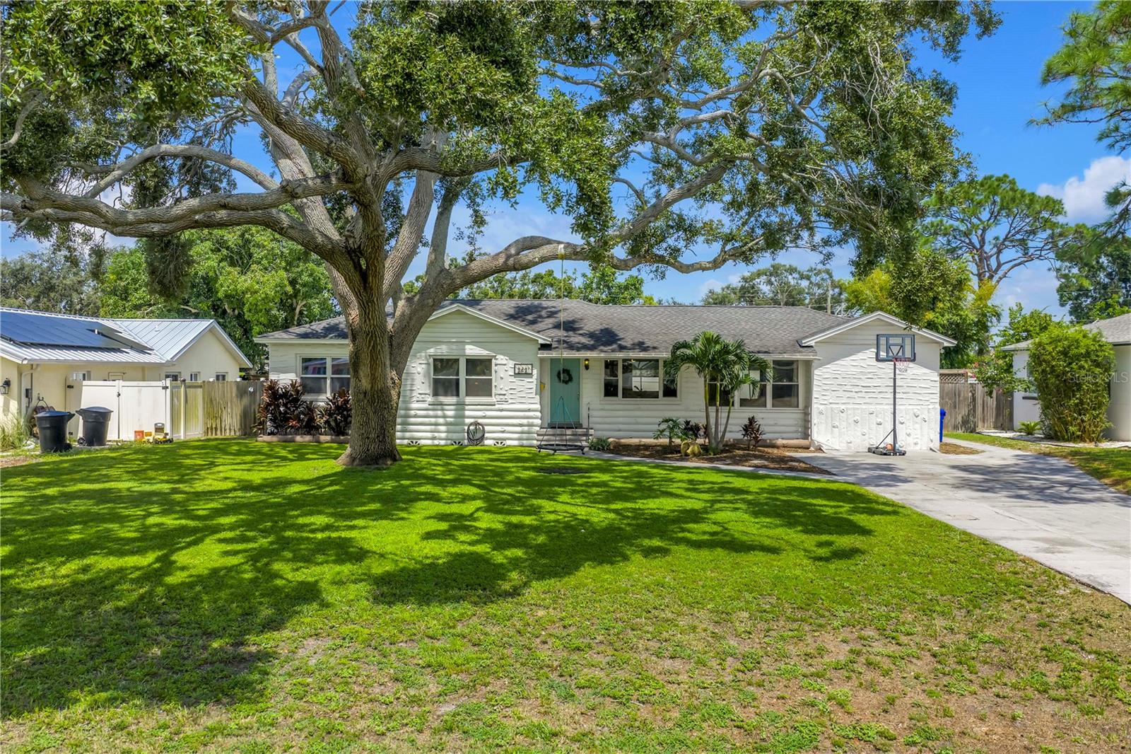 Welcome to this beautifully renovated 4-bedroom, 2-bath home featuring a thoughtful split floor plan on a large 1/4 acre lot in Lakewood Estates. Enjoy the seamless flow of the open living areas, highlighted by modern finishes, updated kitchen and abundant natural light. Master suite features a new ensuite bathroom and walk in closet. Three more bedrooms and hall bathroom all feature smart storage and wood floors. Step outside onto the large cantilevered screened porch — an ideal spot to relax and entertain while enjoying the fresh air in any weather. The expansive backyard is a true outdoor rarity - a flourishing garden space ready for your green thumb, above ground pool, large storage shed, and a charming chicken coop, plus even more yard to make your own! Located high and dry out of the flood zones, it is around the corner from the St. Petersburg Country Club, and just minutes to I-275, downtown St Pete, and the Gulf Beaches. This home blends comfort, style, and practicality, making it a perfect retreat for modern living.