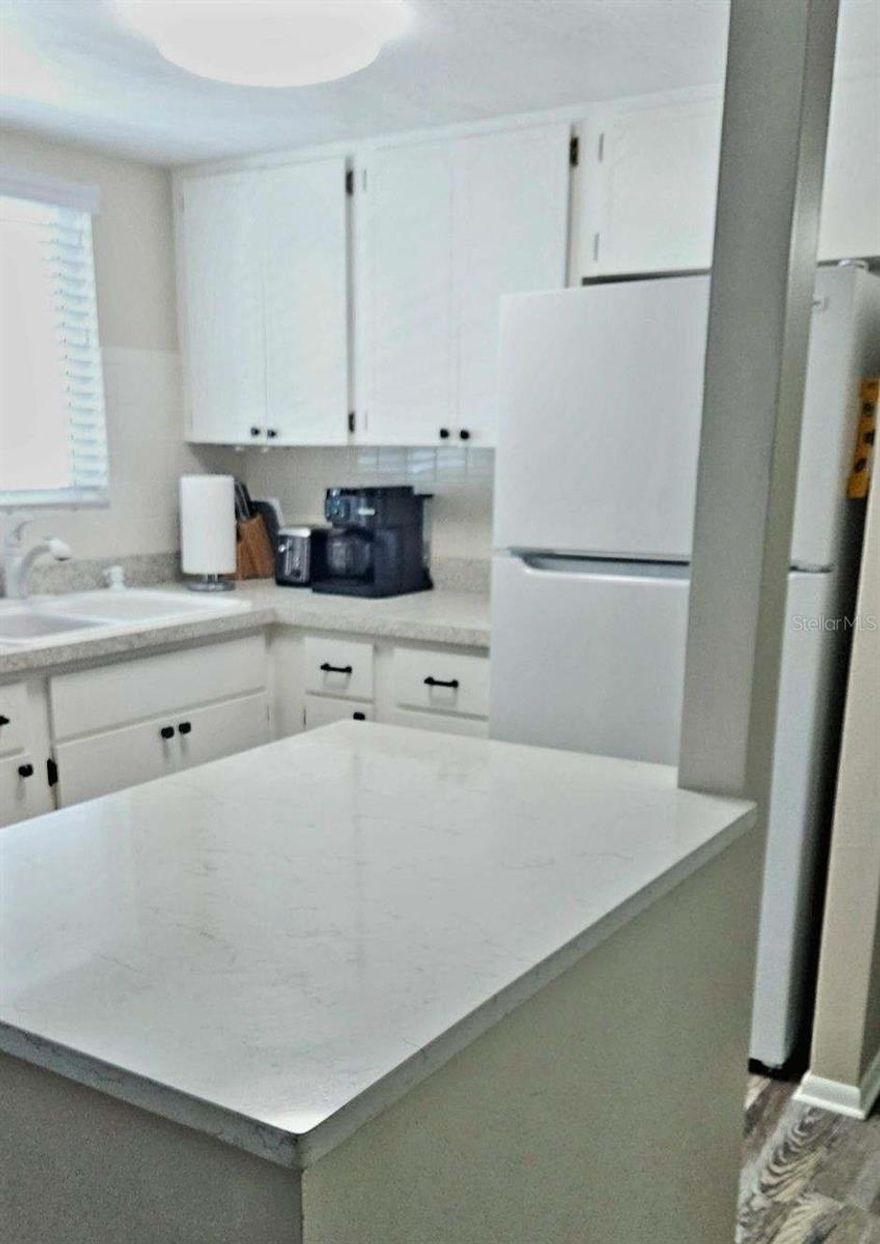 Don't let this one pass you by!  Charming 2-bedroom 1-bath 55+ condo located in the very desirable community of Second Bayshore.  Many upgrades... 2024 HVAC with a newly built-up foundation, the kitchen was recently opened up & tastefully updated, the bathroom was beautifully updated with a step-in shower & all new tile, newer laminate and carpet, replacement double-paned double-lock windows & a high-quality slider recently installed, and so much more... BONUS!! IN-UNIT WASHER/DRYER... Low monthly maintenance fee of just $356.  Parking space #24 is conveniently located near the elevator. This home is just right for easy upkeep and perfect for that Florida getaway.  When you're not lounging on your lanai, you can join in on the many seasonal activities taking place in the community...Just 8 miles away from the sandy beaches of Anna Maria & 20 minutes to SRQ.  Ideally located just a short drive from great shopping centers, including a brand-new Publix, a TJ Maxx, and a Target, almost everything you need is just a short distance away.  Milestone is presently being completed, so the seller is also offering $3,000 toward "possible" upcoming improvements.  Schedule your showing today!