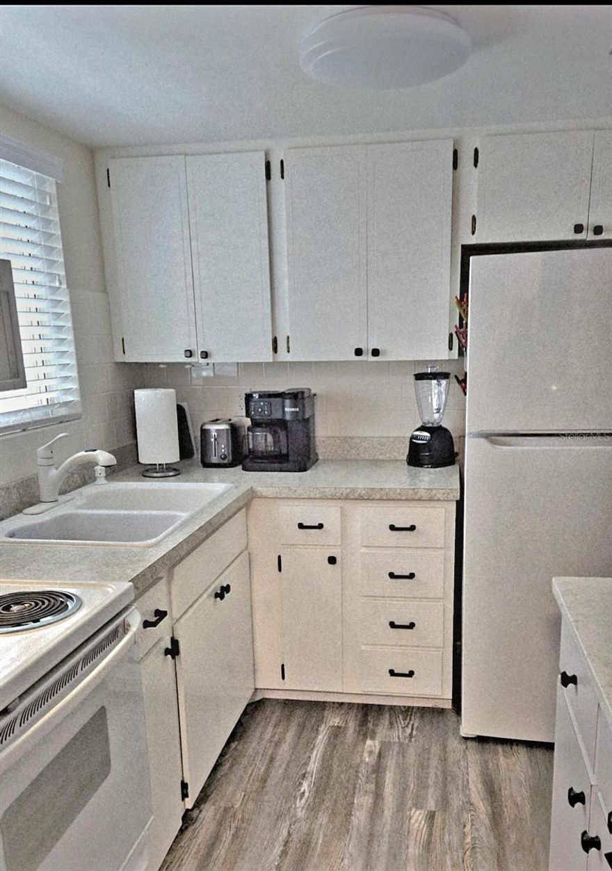 Don't let this one pass you by!  Charming 2-bedroom 1-bath 55+ condo located in the very desirable community of Second Bayshore.  Many upgrades... 2024 HVAC with a newly built-up foundation, the kitchen was recently opened up & tastefully updated, the bathroom was beautifully updated with a step-in shower & all new tile, newer laminate and carpet, replacement double-paned double-lock windows & a high-quality slider recently installed, and so much more... BONUS!! IN-UNIT WASHER/DRYER... Low monthly maintenance fee of just $356.  Parking space #24 is conveniently located near the elevator. This home is just right for easy upkeep and perfect for that Florida getaway.  When you're not lounging on your lanai, you can join in on the many seasonal activities the community has to offer...Just 8 miles away from the sandy beaches of Anna Maria & 20 minutes to SRQ.  Ideally located just a short drive from great shopping centers, including a brand-new Publix, a TJ Maxx, and a Target, almost everything you need is just a short distance away.  Milestone is presently being completed so seller is also offering $3,000 toward "possible" upcoming improvements.  Schedule your showing today!