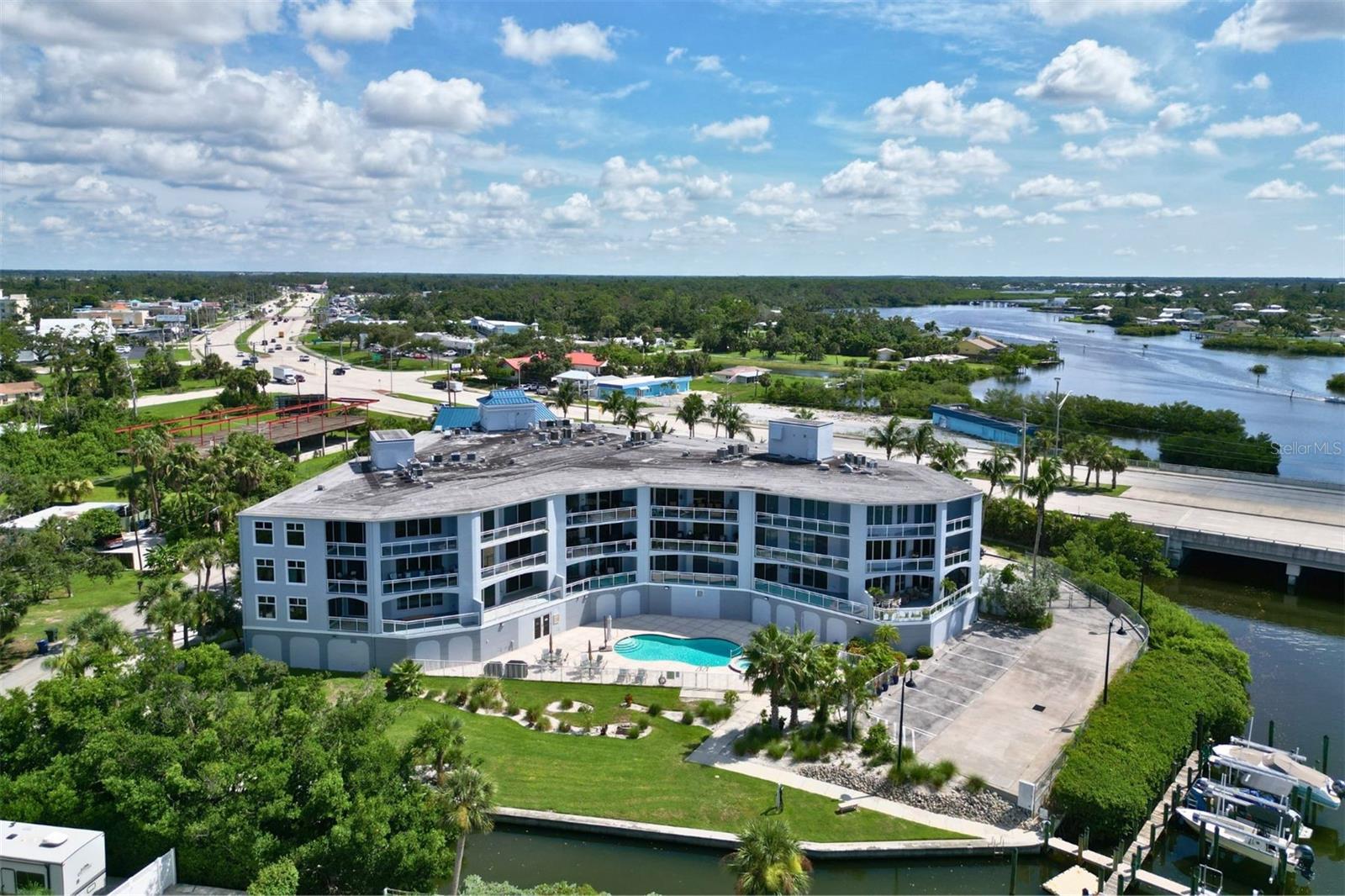 Waterfront mixed use office/retail property with a rare modern upscale living quarters. Not your average workspace! Directly off the private elevator you are greeted with 2 options: Business or Residence. On one side you'll be greeted with an open floor plan, tall ceilings and tons of natural light, perfect for any work space, art studio or professional office use. On the other side and you're greeted with a beautiful custom modern living space, complete with; huge windows full kitchen, bath and bedroom with balcony overlooking the Bay. This space offers the ability to separate or combine business and living space, you can easily have meetings with clients in a private setting and retire to your separate & secure domicile with just a few steps. Modern exterior with views of Donna Bay through your impact-rated windows. Down the hall you'll find high end amenities including a game room, fitness center and just down the elevator you have full access to a pool with a view.
Space comes complete with 2 reserved parking spaces, private parking for customers and secure access to your space.