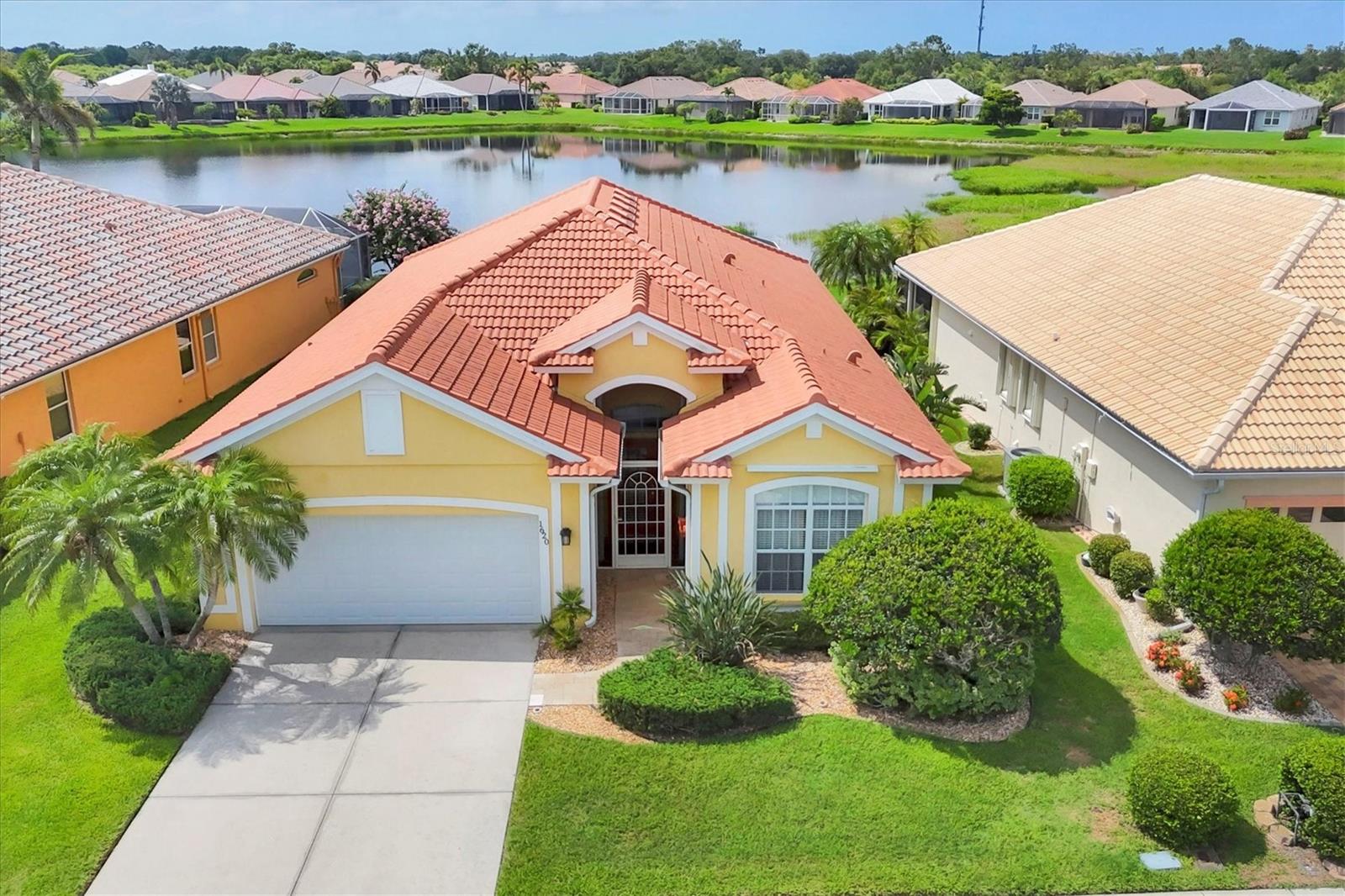 DON'T MISS THIS OPPORTUNITY to own a home in Pelican Pointe with SPECTACULAR LAKE VIEWS and the most popular floor plan in the community!! NEW ROOF. HURRICANE SHUTTERS FOR PEACE OF MIND. The Palmetto floor plan offers 2BD/2BA and DEN. Very open floor plan with high ceilings, grand arches, double tray ceilings, and crown molding. Tile flooring throughout main areas with carpet in bedrooms and den. Updated Fans and Fixtures. Plantation shutters on appropriate windows. GORGEOUS VIEWS from all main rooms. East/South Exposure for a cheery bright home all day long. Perfect for having a happy hour on the lanai or in the pool. Morning coffee on the lanai is in your future!! Gorgeous lanai with Travertine tile. Clearview Screening enhances the view and was just re-screened in 2025. Gourmet Kitchen offers Granite counters, Wood Cabinets, Subway Tile Backsplash, additional recessed lights, and Farmers sink. Clear access to dining area and butlers pantry or dry bar. Open view to living area allows you to watch TV or chat with family or guests while in the kitchen. Breakfast nook area includes that SPECTACULAR VIEW and is a great place to do more than breakfast. Spacious Master bedroom with en suite bath and walk in closet. Master bath has dual sinks and lovely huge walk in shower. Guest bedroom at opposite end of home with adjacent bath. Separate Den with pocket doors can be anything you need-office, den, or sleeping area for guest overflow. IMPACT GARAGE DOOR. IRRIGATION WELL replaced 2022. AC 2020. SEE THIS HOME TODAY BEFORE IT IS GONE!! Not in Florida to see? 3D Walk through at : https://my.matterport.com/show/?m=NHmfkrcVH6h This beautifully decorated home can come TURNKEY FURNISHED under separate negotiation. Pelican Pointe is Venice's premier community with resort style amenities- Clubhouse with restaurant/bar/grill, heated pool, fitness center, tennis courts, pickle ball, tons of social activities, social room/library, 27 holes of golf and pro shop. Huge and very active Women’s Association with tons of activities to choose from. Golf membership is NOT mandatory. LOW HOA fees include use of all amenities, plus cable, internet, and grass cutting. All centrally located minutes to Venice Beach, Venice Downtown, shopping, theatres, restaurants, highways, airports, and so much more. Come find your Florida Lifestyle today!