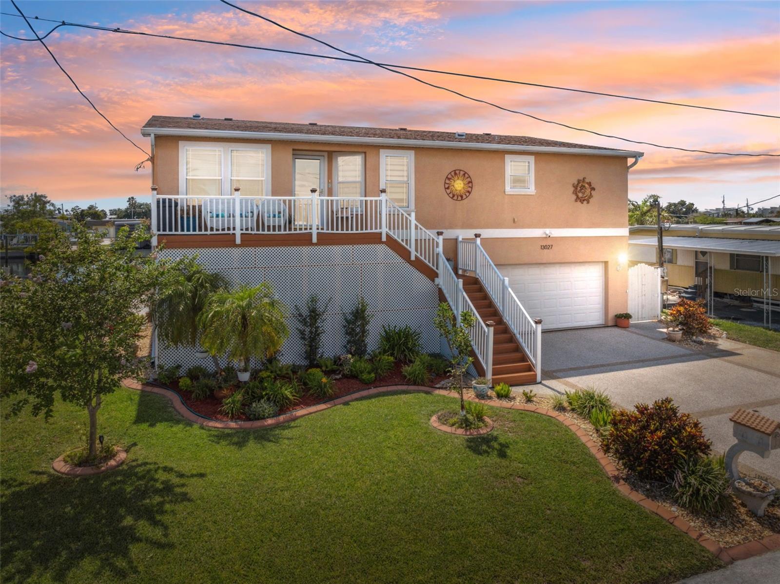 Priced below recent appraisal!! This spacious 1,916 sq ft single-family home offers the perfect blend of open-concept living and serene waterfront lifestyle on a saltwater canal just two turns from the open Gulf of Mexico. Elevated and thoughtfully designed with a split-bedroom floor plan, this stilted home welcomes you with a large front patio—perfect for enjoying the Florida breeze with a morning coffee or relaxing in the shade as the sun sets. Inside, crown molding runs throughout every room, adding timeless charm and elegance. To the right of the foyer, the kitchen features granite countertops, stainless steel appliances, an eat-in dining nook with windows, a breakfast bar for casual dining, and luxury vinyl flooring that mimics the warmth of real wood. The main living and dining areas are carpeted and connected in an open layout, with a tray ceiling above the dining space and a wall of windows in the living room offering serene water views and remote-controlled window shades. Built-in shelving adds function and character. The primary suite—recently updated—is a peaceful retreat with plush carpet, a tray ceiling, two walk-in closets, and large windows that capture tranquil canal views. The ensuite bathroom includes granite counters, dual sinks, a seated vanity, and a frameless step-in shower with built-in bench. French doors lead from the primary to a separate family room with windows on three sides and luxury vinyl flooring, perfect for a quiet reading area or additional living space. Beyond that, the enclosed Florida room provides panoramic water views and transforms into a romantic escape at night. Outdoor living is a highlight, with beautifully landscaped surroundings, two covered patios featuring eye-catching tile flooring and remote-controlled shade screens, an outdoor kitchen with grill and bar, and a hot tub with a brand-new motor. Boaters and anglers will love the dual docks, including a floating dock with 10,000 lb and 15,000 lb lifts, composite decking, and water and electrical hookups. It's also a fantastic fishing spot under the dock. The oversized four-car garage offers space for vehicles, storage, and a full workshop setup. Two additional utility areas—one beneath the front stairs and one under the back stairs—add even more functional storage. A cargo lift makes hauling groceries and gear easy. For peace of mind, security cameras are installed at both the front and back of the home, along with a motion sensor light at the rear stairs. Located close to restaurants, grocery stores, banks, doctors, and all essential amenities, and with no HOA, this home offers everyday convenience with the beauty of the coast. It's just 7.8 miles from SunWest Park, 6.3 miles from Hudson Beach, and only 6.5 miles from the Veterans/Suncoast Parkway, giving you fast access to Tampa and surrounding areas while still enjoying the quiet charm of waterfront living.