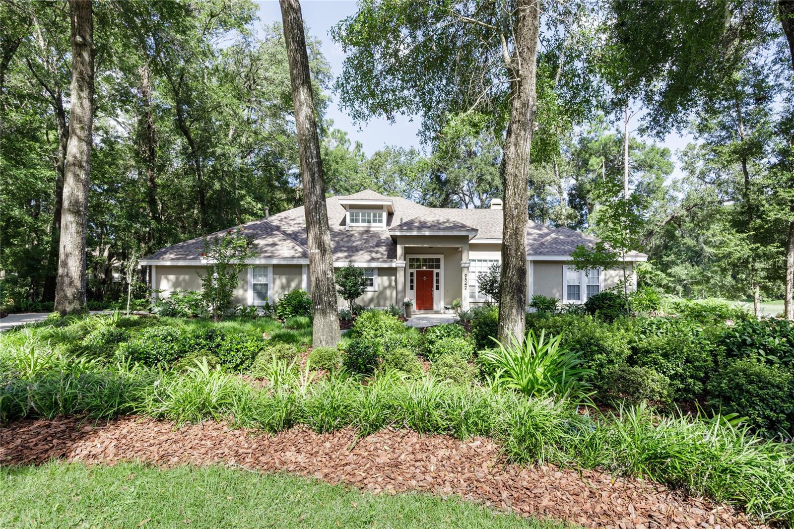 Exquisite Haile Plantation Pool Home on Golf Course – A True Model Home. Tucked away in a quiet cul-de-sac and perfectly positioned along the prestigious Hawkstone Country Club & Golf Course, this stunning pool home radiates elegance and sophistication. With exceptional design and meticulous attention to detail, this residence shows like a true model home—an absolute must-see. Offering 4 bedrooms and 3 full bathrooms, or the flexibility of a 3/3 with a spacious bonus room, the open-concept floor plan invites both comfort and style. Rich wood flooring flows seamlessly through the main living areas—including the family room, formal dining space, kitchen, and walkways—complemented by a soothing neutral palette throughout. A charming front dormer acts as a natural skylight, bathing the kitchen and dining areas in soft, ambient light. The chef-inspired kitchen is a showstopper, featuring stainless steel appliances, a farmhouse sink, solid stone countertops, and elegant wood cabinetry. It opens gracefully to the family room, where you’ll find a cozy wood-burning fireplace, custom built-in shelving, and a tray ceiling with ambient lighting—perfect for intimate evenings or upscale entertaining. French doors lead to an expansive screened lanai and sparkling pool area, offering serene views of the manicured golf course—an idyllic setting for outdoor living. Just off the kitchen, the laundry room is impressively appointed with custom wood cabinetry and large windows that fill the space with natural light. The primary suite is a luxurious retreat, complete with plantation shutters, double vanities, a soaking tub, and a walk-in closet with custom wood shelving. Additional highlights include: Elegant pavered walkway leading to the front entry, recently refreshed mulch and mature landscaping, enhancing curb appeal. This home perfectly balances comfort, luxury, and lifestyle. Don’t miss the opportunity to call it your own. Contact us today to schedule your private tour.