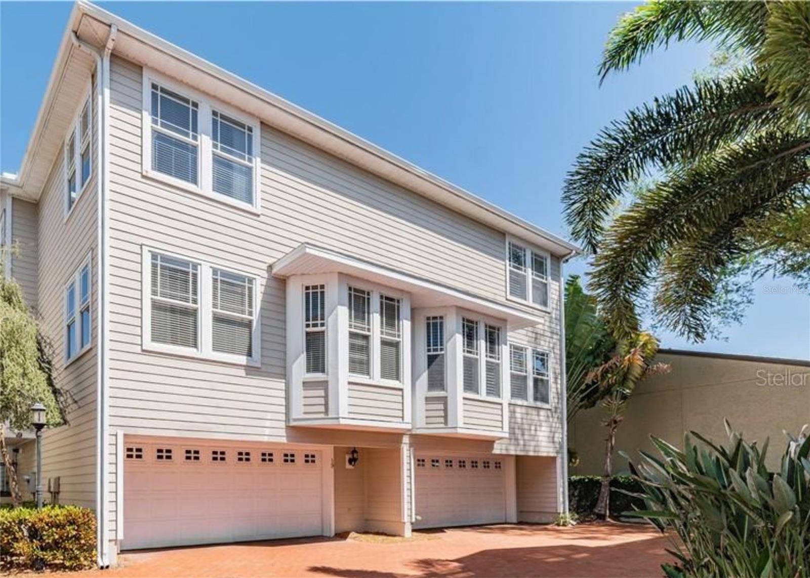 One or more photo(s) has been virtually staged. Available October 1st for quick move-in. Beautifully updated and full of charm, this tri-level townhome in the gated Southgate community offers stylish living in the heart of South Tampa. With 3 bedrooms, 3 full bathrooms, 1,930 square feet of thoughtfully designed interior, and a 2-car garage,. This home blends functionality and elegance in one of South Tampa’s most desirable locations. The first floor welcomes you into a warm and inviting living room with soaring ceilings, a gas-burning fireplace, TV plus sound system, hardwood flooring throughout, and abundant windows that flood the space with natural light. The second level features the main hub of the home, including a bright, eat-in kitchen equipped with stainless steel appliances, a gas range, custom tile backsplash, pantry, and a cozy bay window. The adjacent dining area and full guest bath complement the layout, along with a spacious bedroom perfect for guests or an office. The luxurious primary suite awaits on the third floor—a peaceful retreat featuring a custom walk-in closet and a spa-inspired ensuite bath with double vanities, marble tile, a soaking tub, walk-in shower, and a private water closet. An additional upstairs bedroom also includes its own ensuite bath, providing privacy and comfort. A full laundry room is conveniently located just outside the upstairs bedrooms for ease of use. Step outside to enjoy your private back patio, or take a short stroll to the community pool and grilling area. Southgate residents enjoy exceptional amenities, cable, internet, water, sewer, and trash within the lease. Located just minutes from Bayshore Boulevard, Hyde Park Village, Downtown Tampa, Tampa General Hospital, and top-rated schools including Plant High School—this townhome offers convenience, character, and the very best of Florida living.
