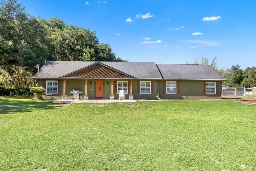 Welcome to this beautifully maintained 3-bedroom, 2-bath home located in desirable North Plant City, offering space, comfort, and versatility on just under ¾ of an acre. With this property being zoned Agricultural and NO HOA, you can bring your animals, boats, or RVs here! This split floor plan home features an open-concept layout with both a living room and family room, perfect for everyday living and entertaining.  The spacious kitchen is the heart of the home, showcasing a large island with breakfast bar seating, ample cabinetry, and seamless flow into the dining and living areas. The inviting family room features a stylish electric fireplace with a stone accent wall, creating a warm and modern focal point.  Plantation shutters throughout the home add charm, privacy, and energy efficiency.  The primary suite is truly a retreat, offering an expansive layout with a private seating area, abundant natural light, and French doors leading to one of two patios. The en suite bathroom includes double vanities, a walk-in shower, and a private water closet, along with a generous walk-in closet.  On the opposite side of the home, you’ll find two additional bedrooms, a full bathroom, and a spacious laundry room. From this side of the home, you have convenient access to a second back patio, which can be reached either through the family room or from the hallway near the secondary bedrooms.  Just off the family room, you’ll also find a cozy screened-in area featuring a hot tub, perfect for relaxing while still enjoying the outdoors. The backyard continues to impress with a dedicated firepit area, ideal for entertaining! The back of the property boasts a large outbuilding featuring a one-car garage and ample storage space in the main area, along with two additional rooms that can be customized to fit your needs- whether for a workshop, hobby space, office, or even more storage.  The fully fenced property includes a large driveway with a double gate, providing both privacy and easy access. Major updates include a drain field (2018), well (2024), and a filtration system (2025) for added peace of mind. Worry free as this is a NON-flood zone! This property offers the perfect combination of indoor comfort, outdoor living, and functional space.  This home is in an ever-growing area but still has the peace and tranquility to accompany. This property is just 15 minutes to 301 or I-4 for easy commuting, and less than 45 minutes to Tampa International Airport and is eligible for USDA financing with $0 down. Don’t miss your opportunity to make it yours!