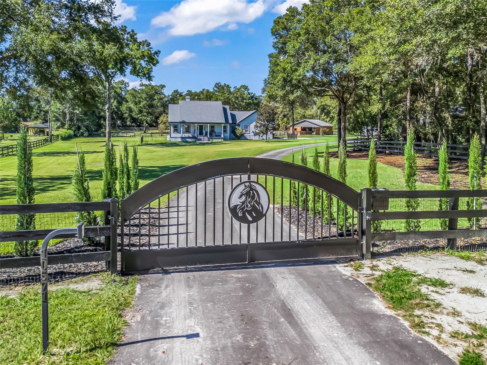 Beautifully Updated Mini Farm Just 2 Miles from the World Equestrian Center! This 3 bed, 2 bath, plus office home has outstanding improvements all done in the past year! Updates include a brand-new roof, new gutters, paved driveway, new electric front gate, fenced front yard, landscaping, irrigation, fresh interior paint, completely resurfaced pool and pool deck, new Trex decking on the front and back porches and an Aquasana water system with UV light for superior water quality. The bright open floor plan with cathedral ceilings features a chef’s kitchen with a granite island, butcher block, custom cabinets, stainless appliances, and huge walk-in pantry. The large back porch overlooks the sparkling pool with Sonos surround sound and TV—perfect for entertaining or relaxing outside. Equestrian amenities include a brand-new 2-stall barn with an air-conditioned tack/feed room and wash stall with hot and cold water. Each stall is equipped with fans, Nelson waterers, and stall mattress systems. Each stall opens up to individual paddocks with new fencing and a concrete auto water trough. The property also offers an expansive storage garage with two open bays, one enclosed bay, and a 42x24 air-conditioned office/workshop. This property truly has it all—modern comfort, quality construction, and a dream setup for both you and your horses, all just minutes from the heart of Ocala’s equestrian community.