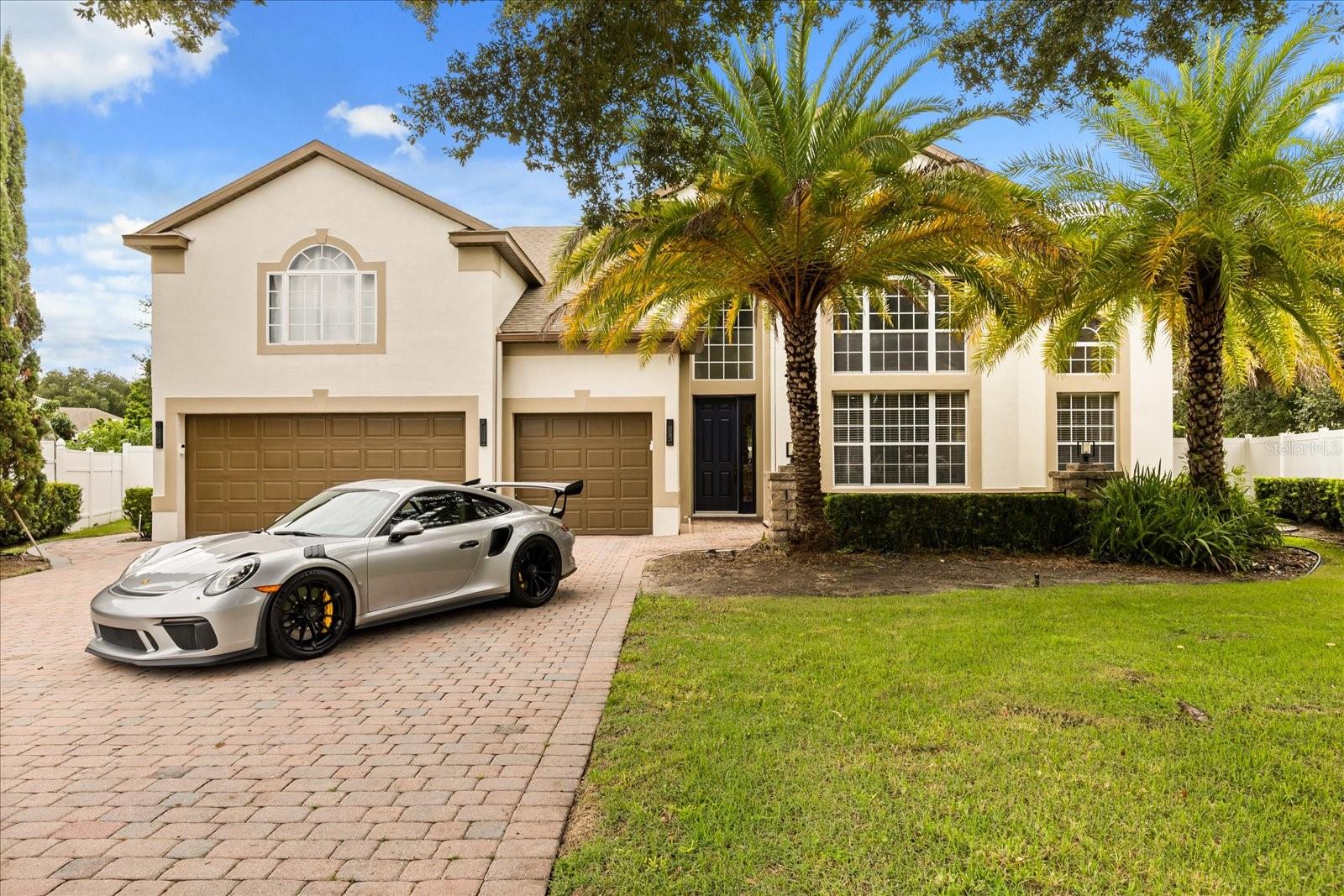 Step into your own private resort at 3013 Spicenut Ct — a 7-bedroom, 5.5-bath estate tucked away on a quiet cul-de-sac in Ocoee’s desirable Forest Trails. With 3,753 square feet of living space, this home was designed for both comfort and memorable gatherings.
The first-floor owner’s suite features a spa bath and private access to the covered porch and pool. Upstairs, three bedrooms enjoy private balconies, including one oversized bedroom with the largest balcony overlooking the landscaped grounds. A versatile studio-style suite with full bath and kitchenette provides flexible options for multigenerational living, extended guests, or a media/game retreat. Two additional bedrooms complete the upstairs wings, each served by full baths.
The backyard is a true highlight: a 20’x35’ saltwater pool with water features, dual outdoor showers, a custom gazebo, and a full summer kitchen. Surrounding the home is a professionally designed outdoor living environment with six-figure landscaping and hardscape investments — including Canary Island date palms, live oaks, magnolias, layered hedging, and custom paver design — creating privacy and an estate feel rarely found in Central Florida.
Inside, the open-concept plan flows between family spaces and entertaining areas, complemented by a game/media room with electric fireplace, formal dining, and multiple flex areas. A laundry/mudroom with direct pool bath access adds practical convenience.
This estate blends timeless design, luxury outdoor living, and multigenerational functionality — all within minutes of shopping, dining, and top-rated schools.