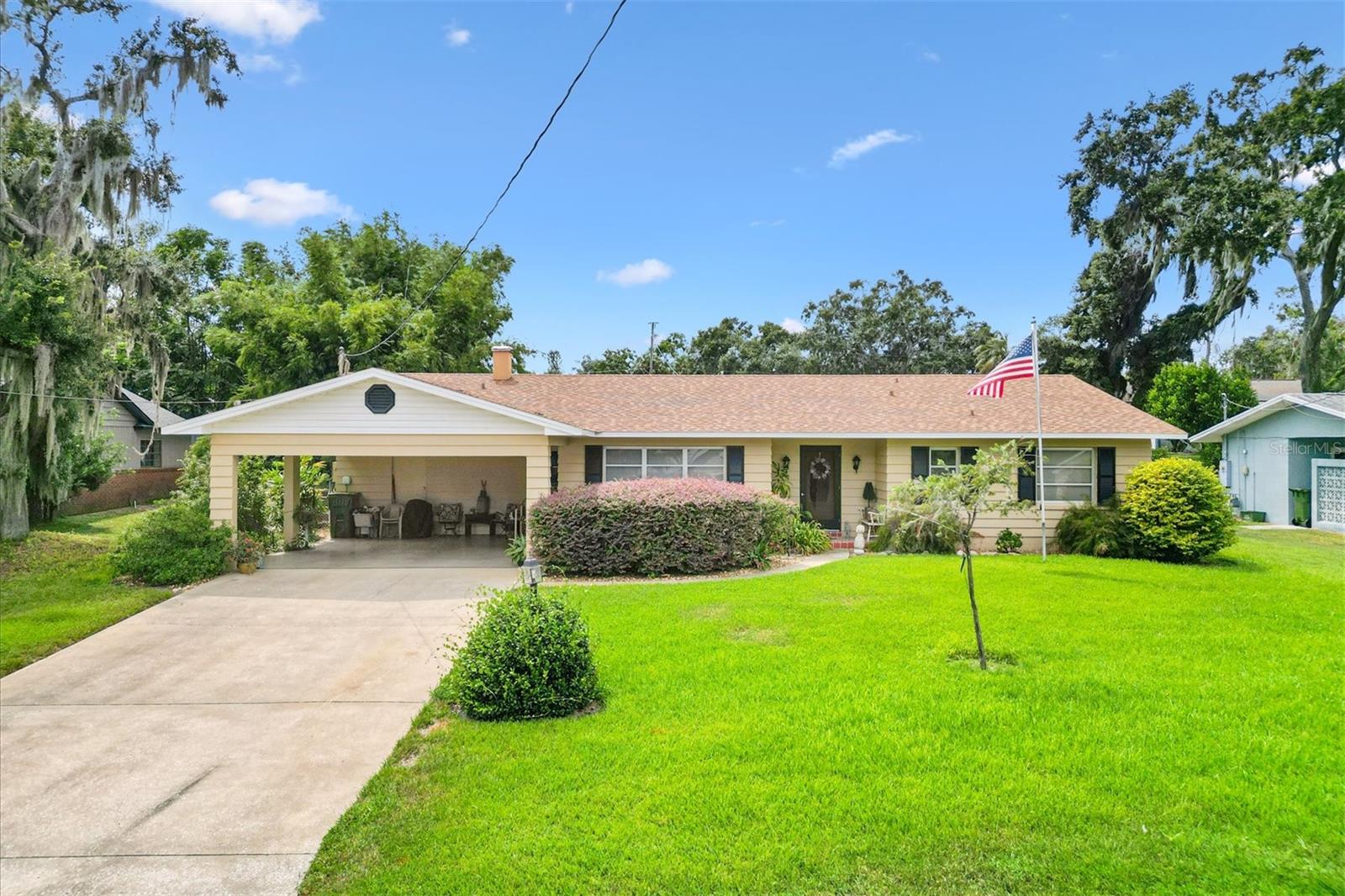 WELCOME HOME to this beautifully maintained 4-bedroom, 3-bathroom home offering 2,208 SF of versatile living space, including a 448 SF in-law suite with a private entrance—perfect for rental income, multi-generational living, or a private guest retreat. The in-law suite is complete with tile and carpet, its own bathroom, and living area with pool access. You will definitely enjoy the resort-style backyard oasis with a sparkling pool, paver patio, and lush tropical landscaping—an ideal spot to relax and catch breathtaking sunsets at the end of the day.
Step inside the main home to find timeless terrazzo floors, 3 bedrooms, 2 bathrooms, dining room, living room, den and a beautifully remodeled kitchen perfect for the Chef of the house. The kitchen features rich cinnamon-colored cabinets with black glaze trim. A big plus is the spacious 4x8 cooking island with lower storage and pot drawers. There is a double-door pantry, tons of storage, hi-def laminate countertops and stainless steel appliances. Roof was replaced in 2022. The property also features handicap accessibility, block stucco construction, fenced yard, storage shed and curb appeal galore with beautifully manicured landscaping. Located just steps from Lake Griffin, where you can fish, canoe, kayak, stroll by the water, or sip your morning coffee watching the sunrise. There's also a park with a playground. This is a perfect place to bring your chairs to watch the space shuttles! You will love the convenient access to shopping, schools, public transportation and so much more. This charming home has great bones, tons of character, and endless potential—a must-see! Call Me Today for a Private Showing. You will be impressed! NOTE: CHANDELIER IN DINING ROOM AND FOYER DO NOT CONVEY. POTTED PLANTS AND ROCKS AT FRONT DOOR AREA DO NOT CONVEY.