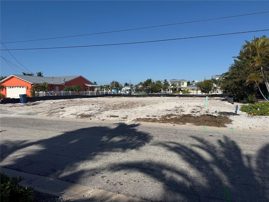 Prime Waterfront Opportunity on the Grand Canal – Holmes Beach, Anna Maria Island

Nestled along the expansive Grand Canal—the largest and most sought after on Anna Maria Island—this rare vacant lot presents an extraordinary canvas for discerning buyers seeking unparalleled waterfront luxury. Fully cleared following the October 2025 demolition of the previous residence, this highly desirable parcel offers sweeping, unobstructed water views and direct, deep-water access ideal for boating, fishing, and the quintessential island lifestyle.

In one of Florida's most coveted beach towns—where pristine white-sand shores, boutique shopping, acclaimed dining, and a timeless, laid-back ambiance draw residents and visitors alike—this location is among the most sought-after on the island. Moments from the Gulf of Mexico's turquoise waters, yet embraced by the serene beauty of the canal, the property promises a lifestyle of effortless elegance and natural tranquility.

A significant advantage awaits the astute buyer: Manatee County's impact fee policies generally provide credit for the prior residential structure on replacement builds (without a strict 2-year time limit for the credit to apply, though prompt action is recommended amid evolving fee schedules). This can substantially reduce costs for a new custom residence compared to entirely new development elsewhere. (Buyer and buyers representation strongly encouraged to consult directly with Manatee County Development Services for site-specific confirmation, as policies are subject to the current ordinance.)

With generous dimensions and the island's signature waterfront allure—qualities increasingly scarce in this paradise—this lot invites the creation of a bespoke estate tailored to your vision: a modern coastal masterpiece with private dock, infinity-edge pool, and expansive terraces framing panoramic sunsets, the possibilities are endless.

For those envisioning their ultimate Florida retreat, this is a singular chance to craft a legacy property in one of the nation's premier island destinations. Opportunities of this caliber rarely arise—seize the moment to make this piece of paradise your own. Don't hesitate to make your appointment today for exclusive details and to arrange a private viewing.