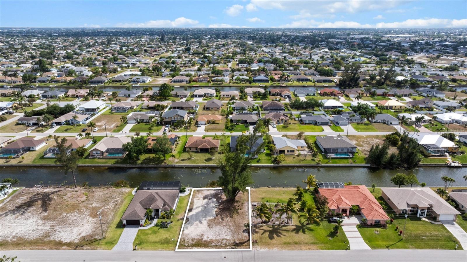Discover the perfect opportunity to build your dream home on this south facing waterfront lot, ideally situated on a peaceful freshwater canal—perfect for kayaking, wildlife watching, or simply enjoying the tranquil water views. This is a perfect place to enjoy outdoor living on your private lanai or floating in your pool. Located in an established neighborhood with attractive neighboring homes, this lot offers a sense of community while remaining close to everyday conveniences. Enjoy quick access to shopping, dining, and entertainment just minutes away on Pine Island Road, with even more options within a short drive to Fort Myers and Punta Gorda. Water, sewer, and irrigation connections are available in the neighborhood, with assessments paid, making the building process that much easier. Buyer to assume a small remaining payoff balance of the sewer assessment of under $1000.