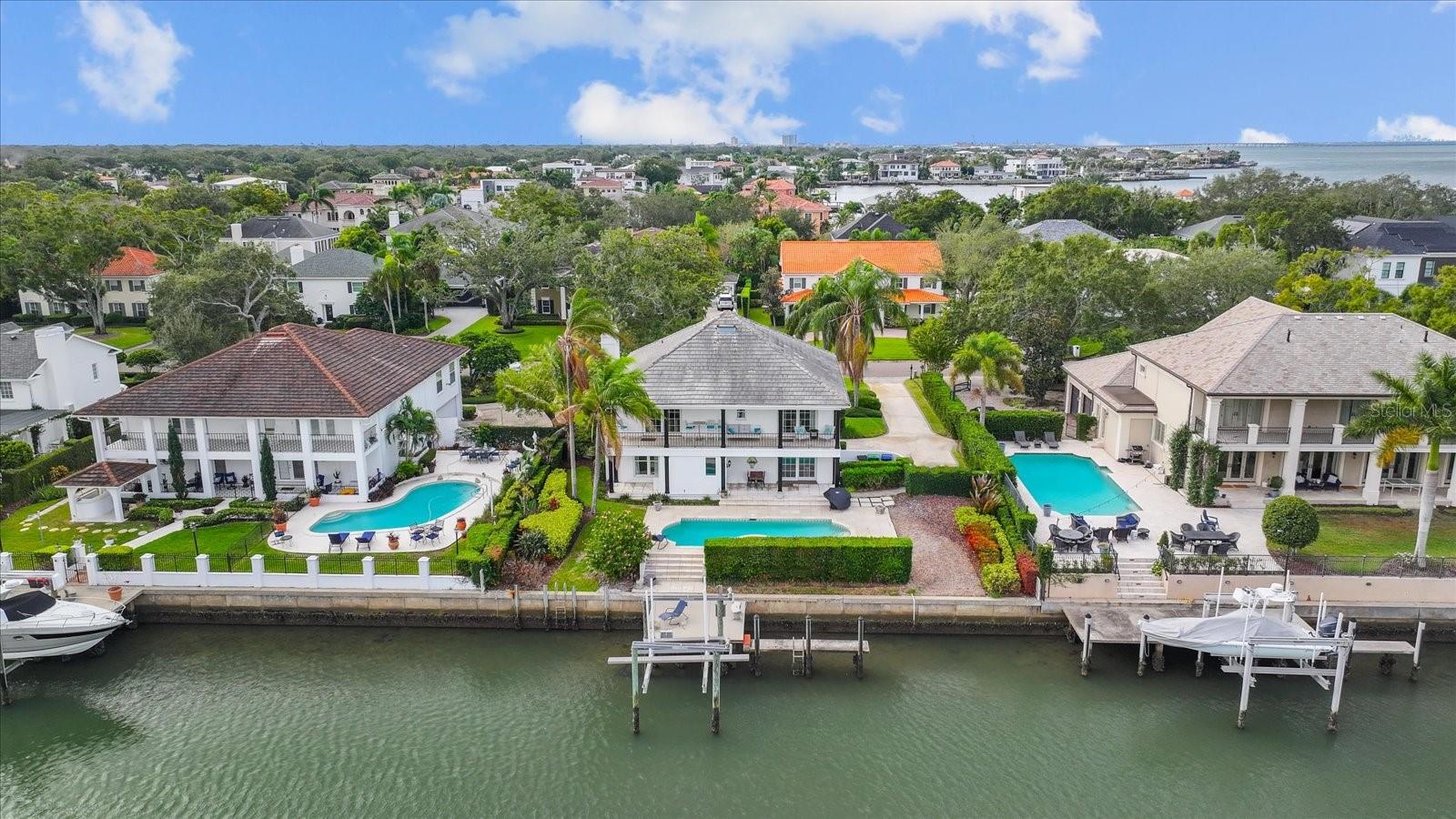 Available for Lease, take a look at this beautiful waterfront pool home in the highly sought-after gated community of Culbreath Isles. Fully furnished, even the coffee maker is included. Short-term rental is also available for a higher rent rate. This home is located in an A-rated school district, close to bridges, airports, dining, and shopping. This is a tropical paradise perfect for entertaining guests. The backyard features a concrete seawall and dock with a boat lift, travertine pool deck, covered patio, salt water pool/spa, and it is situated on the Grand Canal with access to the Bay. Just bring your kayak, boat, or yacht !! This home features a grand elevated front entrance, dual spiral staircase, side entry double bay garage, and a multi-column front porch. The second floor features a spectacular kitchen, family room, dining room, living room, and master suite. The private balcony offers stunning views of the deep Grand Canal. The kitchen living room combo features travertine flooring throughout, solid wood cabinetry, granite counter tops, stainless appliances including a Subzero fridge, a built-in wine fridge, an island seating that opens to the living room stone fireplace. Washer and dryer included. Newer impact double pane Pella hurricane windows, patio sliders, and doors. Step downstairs to the remaining bedrooms, which can double as a home office, gym, flex space, or nursery. Brick flooring throughout common areas leads to the living room featuring a wet bar. All this and just minutes to Tampa's top public and private schools, world-class shopping, sports arenas for our Super Bowl Champions and Stanley Cup Winners, Florida's top-rated beaches, and only minutes to Tampa International Airport.