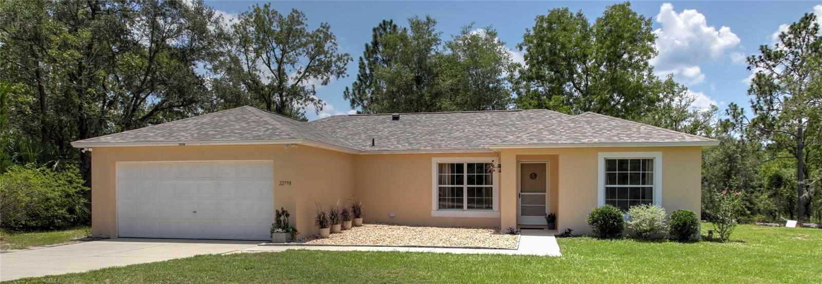 Peaceful living, yet still close to conveniences! This immaculately clean, move-in ready, 3 bed, 2 bath, 2 car-garage home on essentially 2 acres is ready for you! Classic split-plan, Master bedroom features walk-in closet, and an oversized garden tub/shower combo. New architectural shingle roof and appliances installed in 2021. New HVAC installed in 2020. Seller says enjoy the deep well with exceptionally clean water! With a raised bed garden, large chicken coop, and fruit trees (kumquat, loquat, mulberry, banana, fig, blueberry bush), this home is perfect for those looking to homestead. Newer utility shed 14 x 10 perfect for extra storage of lawncare equipment and could be used as a workshop. Current owner works from home in tech using high-speed Starlink satellite
internet, so the question of internet is answered! (Viasat satellite also available). Outdoor enthusiasts will love the park-like yard that
has enough space for a pool if desired, in addition to adventures on the river at Rainbow Springs in town all year long. The Marion
County recycling center/trash drop off is just outside of Rainbow Lakes Estates and is on your way into town for easy trash drop off.
You have access to Lake Bonable, Rainbow Lakes Estates Community Center, and Seacliff Park and Playground. These are within
minutes of the home, and yet, there is NO HOA. Oh, and Homestead exemption should apply this year for less taxes! Come see it and make it yours today!