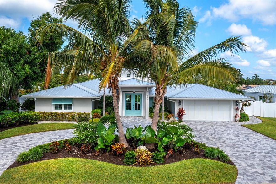 Gorgeous canal-front home in the highly sought after community of Country Club Shores on Longboat Key with expansive open spaces and seamless indoor/outdoor living. Fine details and designer finishes throughout, from the grand open living area with natural light and marble and wood floors to the wood and beam detailed vaulted ceiling with custom build-out and coastal window skylights. The kitchen features a large quartz waterfall island and custom built-in Thermador appliances, while the primary suite boasts dual sinks, walk-in shower, and soaking tub. All other bedrooms are en-suite with high-end finishes.  Relax or entertain outside on the covered patio with a gas fireplace, or lounge by the sparkling pool. A new composite dock with a jet ski and 30,000-lb lift on sailboat water offers you direct access to the Intracoastal waters and the Gulf. Easily hop on your boat, jet ski, kayak, or paddleboard to explore the beauty of natural Florida from your very own backyard. Located on one of the prettiest streets on Longboat Key, this home is close to everything the island has to offer, including private resident beach access and Longboat Key Club golf or social memberships. St. Armand's Circle's boutique shops, fine restaurants, entertainment and local events are only minutes away as is Downtown Sarasota with its lively vibe, and its art and cultural destinations.