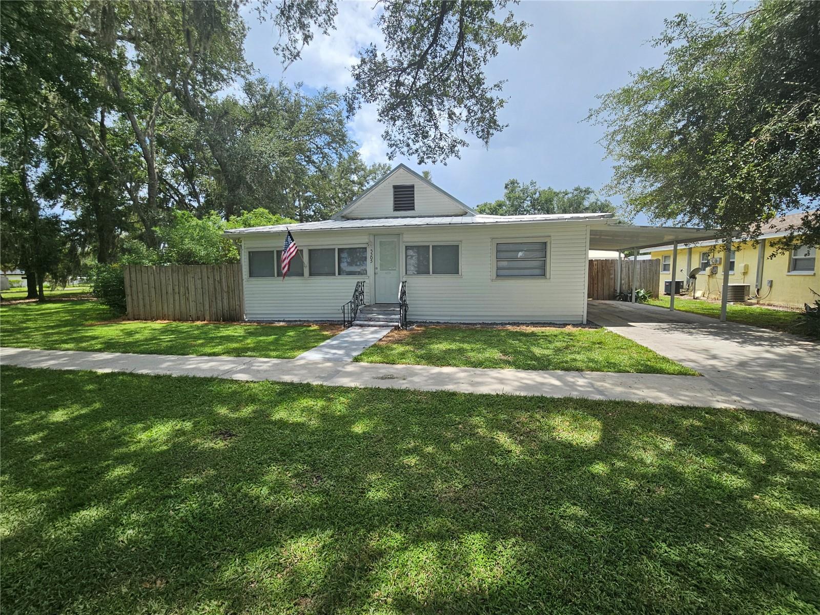 Stop buying a house for your landlord... Take advantage of this AFFORDABLE, CLEAN, MOVE IN READY home and ditch the rent. Become a homeowner for about the same cost as renting. This home has updated flooring with easy to clean vinyl plank floor covering. Main AC was installed 2019 and mini split unit is brand new. Home features some double pane windows and a silver metal roof for energy efficiency. Floor plan offers 2 split bedrooms plus a very spacious kitchen with room for dining area. Also included is a 10'x12' laundry room and workshop for project tinkering or extra storage. Freshly painted and deep cleaned. Located near the heart of the city however offers plenty of privacy with the 6' wood privacy fenced back yard. Fenced back yard is great for pets and kids to safely play. Local elementary, middle, and high schools are less than 1 mile away. Restaurants, banking, and shopping are all within 5 minutes. Within a few blocks to county public bus transportation stop.
