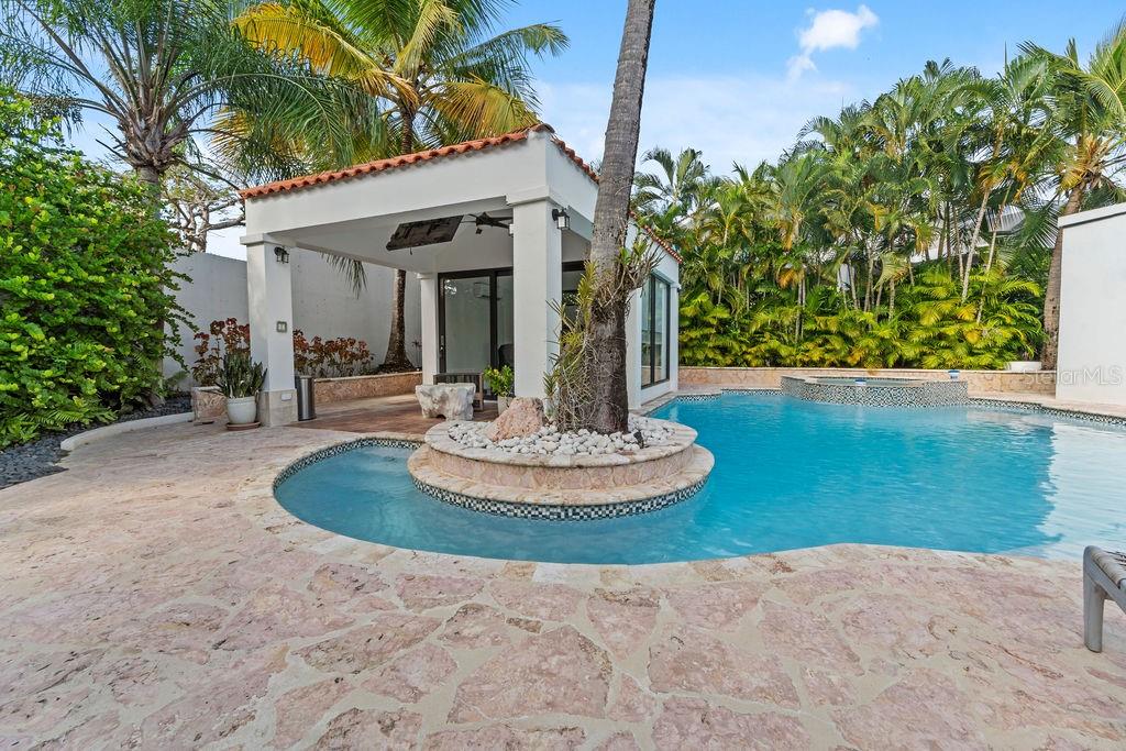Discover the best Dorado Beach East one story home in this fully remodeled and expanded Golfer model home. A true move-in-ready property offered fully furnished and equipped, just pack your toothbrush.
Located on a corner lot in a quiet cul-de-sac, the 1,334-square-meter property offers privacy and convenience near the South Gate of Dorado Beach East.
The outdoor space is designed for relaxation and entertainment, featuring a large pool, an air-conditioned gazebo that doubles as a guest house or office, a cold plunge, an outdoor shower and bathroom, and a BBQ grill area. The lush landscaping, complete with a small pond, creates a serene setting for gatherings or quiet moments.
Inside, the home features 4 spacious bedrooms, 4.5 bathrooms, an open-concept kitchen and dining area, a bright living room with cathedral ceilings, and a TV room that opens to the outdoor space. The master suite includes a spa-like bathroom and a walk-in closet.