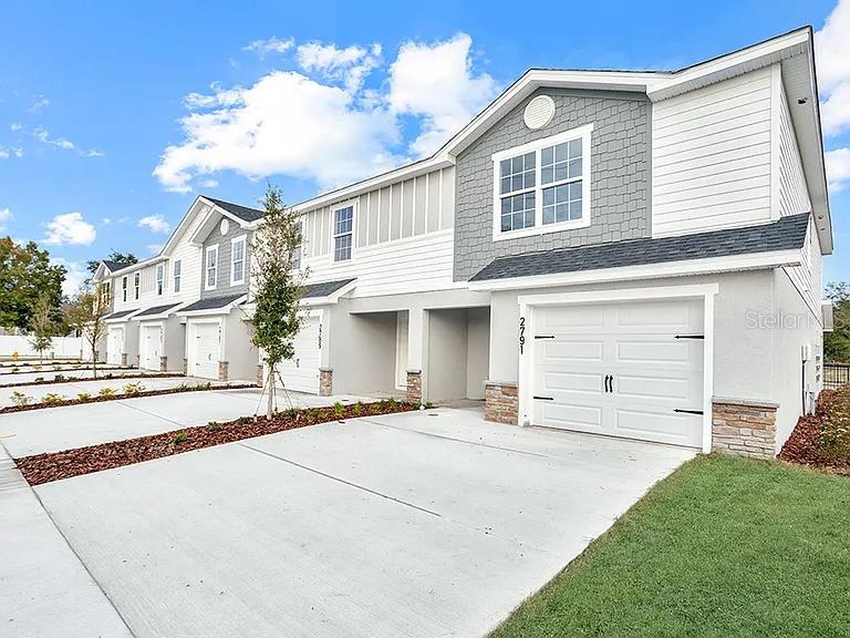 2-story new construction end-unit townhome with 1,884 square feet, 3 bedrooms, a 1-car garage, and a screened lanai, located in the brand-new Terrace at Walden Lake community offering natural and park amenities. Downstairs, enjoy an open layout and a gourmet kitchen with quartz countertops, shaker-style cabinets, Samsung stainless steel appliances, a pantry, and a butterfly island. The spacious gathering room opens to your private screened lanai. The entire lower level and upstairs baths are finished with luxury vinyl plank flooring, with stain-resistant carpet in the bedrooms. Upstairs, you'll find three spacious bedrooms including your owner's suite complete with two walk-in wardrobes and a private en-suite bath with dual vanities, a tiled shower, and a closeted toilet. Additional features for your convenience include a half bath downstairs, Jack-and-Jill upstairs bath for the secondary bedrooms, custom-fit window blinds throughout, a Samsung full-sized washer and dryer, energy-efficient insulation and windows, and a full builder warranty.