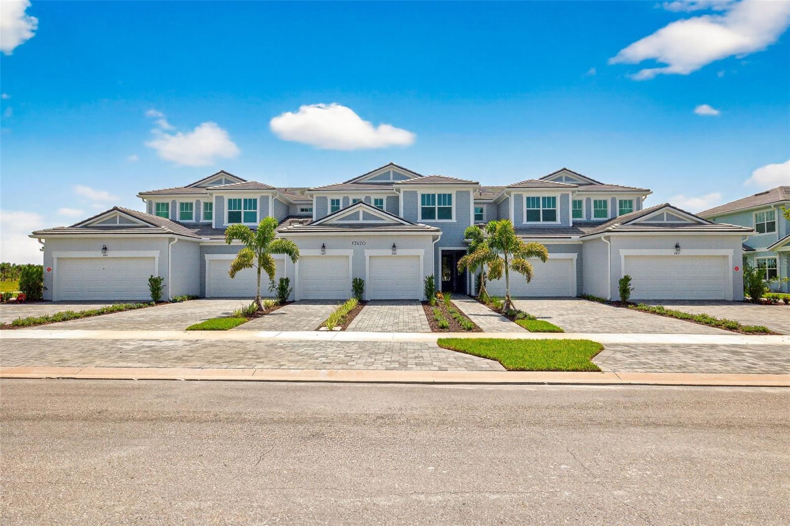 Under Construction. This stunning coastal exterior coach home, located on the bottom level, offers a perfect blend of comfort and style. Featuring an open-concept floor plan, the 1,422 square foot, two-bedroom, two-bath residence boasts a spacious great room that seamlessly connects to the screened lanai through glass sliders, allowing for enjoying early morning coffee or the warm Florida breezes in the evening.
The kitchen is a chef’s dream, showcasing a large island with a breakfast bar that seats five, sleek stainless steel appliances—including an Energy Star-rated refrigerator—gray shaker-style cabinets, and durable marbled quartz countertops. A unique tile backsplash and a double-door pantry complete the space, while plank-style tile flooring flows throughout the main living area.
The expansive owner’s suite is a private retreat, offering a walk-in closet and an en suite bath with a dual sink raised vanity and an oversized glass-enclosed shower with a ledge. The second bath features a zero-entry shower with a glass enclosure for modern convenience. The secondary bedroom is located down a hallway off the kitchen. This provides privacy from the main living space.
This home is equipped with a smart home package for added efficiency and security. Its neutral color palette, energy-saving features, and thoughtfully designed layout make it a perfect blend of coastal elegance and modern functionality. Floorplan and rendering are preliminary. Photos, renderings and plans are for illustrative purposes only and should never be relied upon and may vary from the actual home. Pricing, dimensions and features can change at any time without notice or obligation.