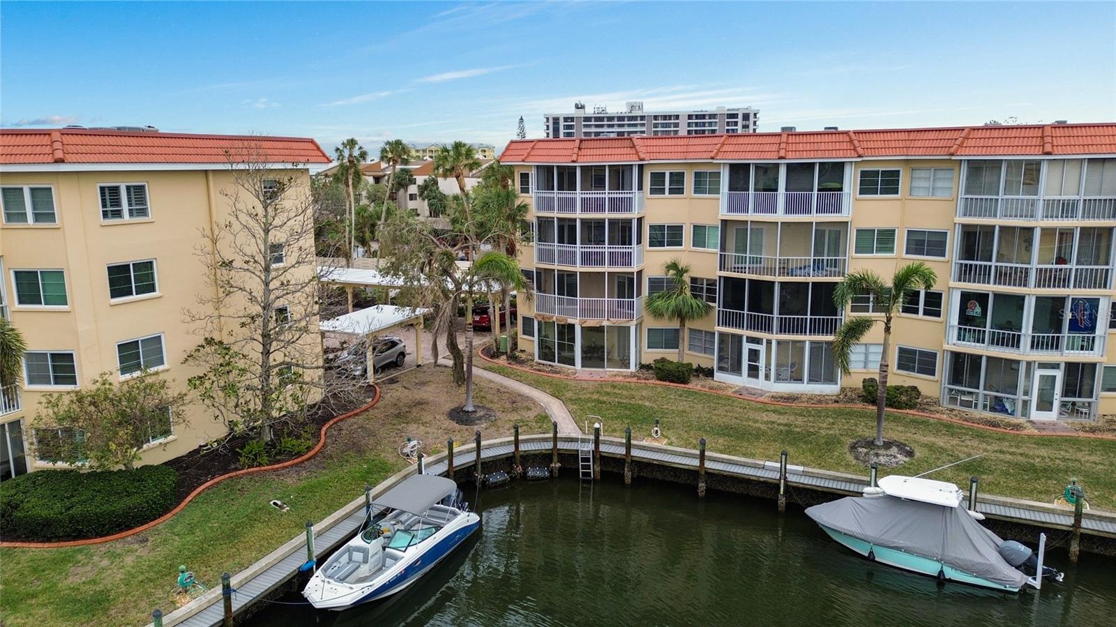 Experience the best of waterfront living in this beautifully furnished, private first floor, end unit in the highly sought-after Siesta Harbor community! This TURNKEY condo offers stunning canal views and a prime location just steps from the beach. This immaculate 2-bedroom, 2-bath corner unit has been fully remodeled and is move-in ready. Featuring impact windows, an enclosed lanai, and gorgeous, high-end furnishings, this home is designed for both comfort and style. The spacious, open-concept living and dining areas flow seamlessly, enhanced by a modern kitchen with white shaker cabinets, quartz countertops, stainless steel appliances and top-tier finishes. The primary suite boasts a walk-in closet and a luxurious stand-up shower. The lanai is the perfect spot for morning coffee or an evening glass of wine, with dolphins often seen playing in the marina. You’ll enjoy easy access to all the amenities, including a heated pool and spa, shuffleboard, a fitness room, saunas, and a clubhouse. This active 55+ community also offers private beach access across the street, free on-site laundry, and a pier on the intracoastal waterway for fishing or just relaxing. Boat slips are available for an annual fee. Whether you're looking for a full-time residence or a rental opportunity, this turn-key condo offers both. Steps from the trolley, local shops, and restaurants, with easy access on and off the key – this location can't be beat. Don't miss your chance to live in one of Sarasota's most desirable locations – this stunning, move-in-ready home is waiting for you!