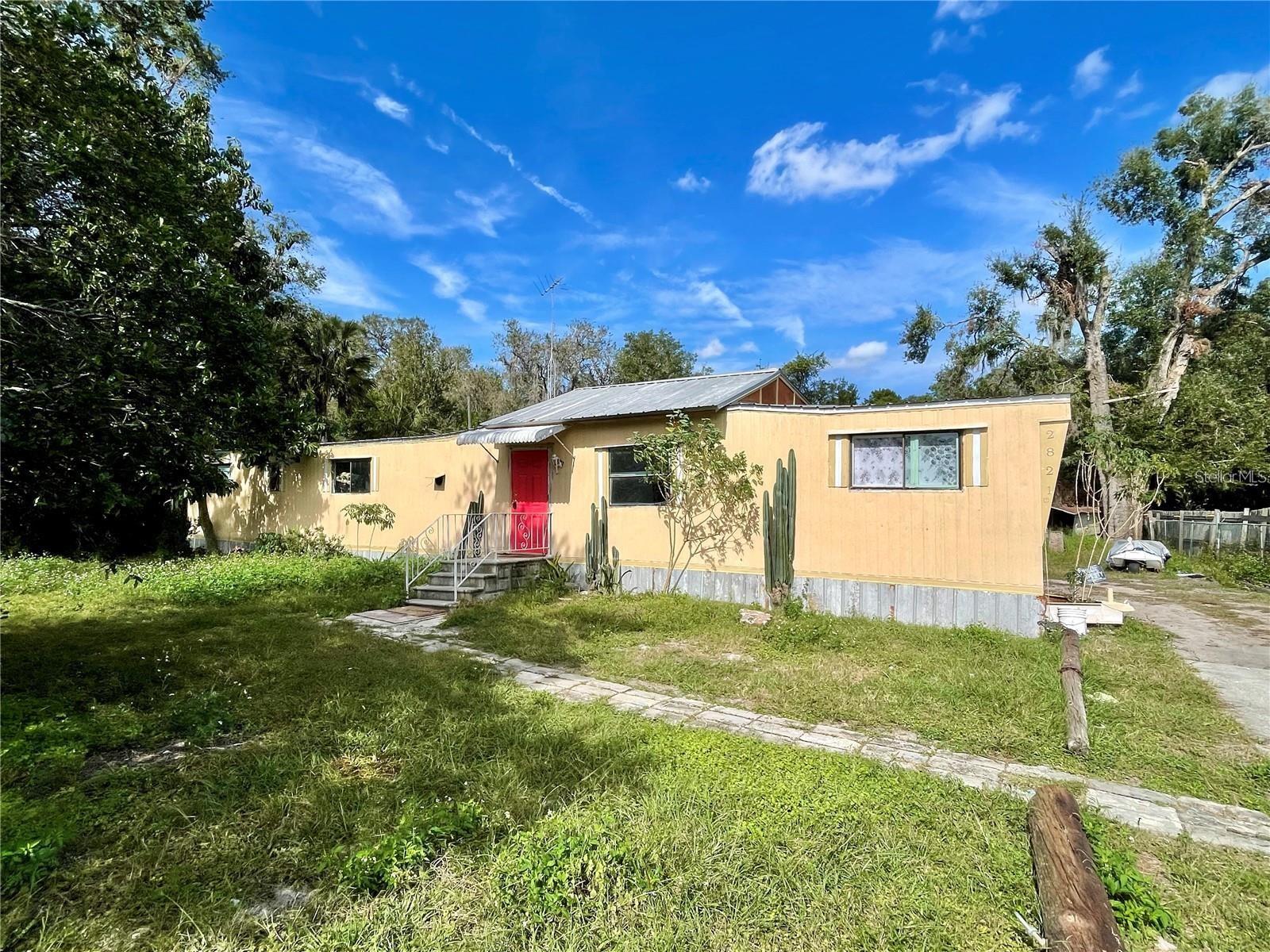 HOME ON 1/4 ACRE NEAR DOWNTOWN EUSTIS - Discover the potential in this 3-bedroom, 2-bath manufactured home, nestled on a nearly quarter-acre lot on a quiet street just minutes from the heart of downtown Eustis. Perfect for investors or those with a vision, this property offers the ideal canvas for a personalized renovation. With ample outdoor space, there's room for gardening, outdoor entertainment, or future expansion. Situated in a charming area close to shopping, dining, and entertainment, this home provides a rare opportunity to create something special in a prime location. Don’t miss out on making this property your next project. Schedule your showing today!