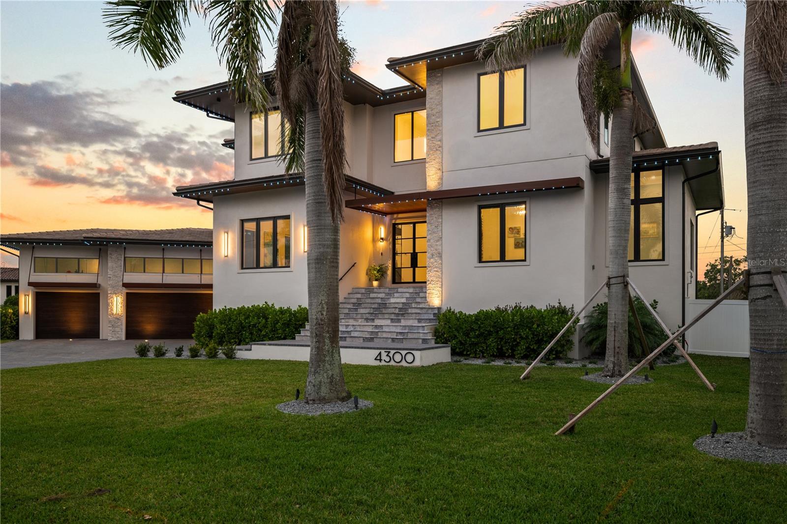 Experience a one-of-a-kind residence on an exceptionally rare lot. 4300 Bayshore Blvd NE is a masterclass of intentional design, exacting standards, and elegant finishes. At 5,795 heated square feet (7,410 sqft total) with six bedrooms, 6.5 baths, an oversized game room, dedicated front office, piano room off the foyer, butler’s pantry, and two dedicated laundry rooms, and a 3 car garage, this home has all the space you could need with refined beauty around every corner. The brief for this custom residence was focused on crafting a warm, welcoming space—one that blends tradition with a refined modern sensibility. From the moment you step through the custom metal doors, you’re met with a sense of calm. A textural timber feature wall draws the eye inward, leading to a handcrafted staircase with sculptural presence. To your left is the dedicated dining room that is emphasized with the art-inspired wine display. As you head towards the kitchen, on your right is the 23’8” x 15’8” bonus game room with 12ft soaring ceilings that serves as a movie theater, kids room, golf simulator, or the private gym you’ve always wanted! Designed with entertaining and everyday family life in mind, the heart of the home unfolds in an open-plan living area anchored by a dramatic built-in fireplace, sprawling chef’s kitchen, and overflowing natural light. The kitchen was conceived through a thoughtful collaboration with a renowned Hamptons designer, showcasing a Thermador appliance package with built-in coffee maker and double wall oven, and a custom island with waterfall edge, seating, and oversized sink. A butler’s pantry offers an apron-front sink, full-size refrigerator, wine fridge, walk-in pantry, and steel-rolled wine and champagne cabinet. Outside, the pool area is your own private resort: mature royal palms, heated saltwater pool with a hand-troweled mini pebble finish, premium wood-look porcelain pavers, and an outdoor shower set the scene for leisure. The greenspace beyond the expansive pool deck is big enough to host a soccer match, build a tennis court, or do some pitch-and-putt right in your backyard! In your covered lanai, a built-in Artisan kitchen lies under tongue-and-groove wood ceilings and is surrounded by tiered planters. Heading upstairs, the master suite is a true retreat. Serene water views and a dedicated lounging area for morning coffee will have you not wanting to leave it. It’s en-suite bath draws inspiration from luxurious European spas and is defined by porcelain timber-look cladding and deep, moody tiles. The palette and materiality create an atmosphere that is both grounding and indulgent. The dual shower and rainfall heads, niche LED lighting, and floating cabinetry elevate the class of the space. Walk right into your dream closet with plenty of room for two, including a custom island and a built-in LG clothes steamer unit. Your own dedicated upstairs laundry room with private access from your master suite features pull-out drying racks to make chores effortless. ALL bedrooms feature en-suite baths with custom vanities, quartz countertops, and floor-to-ceiling tile. The first floor guest suite is perfect for the in-laws and has the second laundry room near the garage. Throughout the home, tactile finishes, an earthy palette, and intentional design elements and contrasts around each corner elevate daily living into an art form. Unlock the dream Florida lifestyle with 4300 Bayshore Blvd NE — book your private showing today!